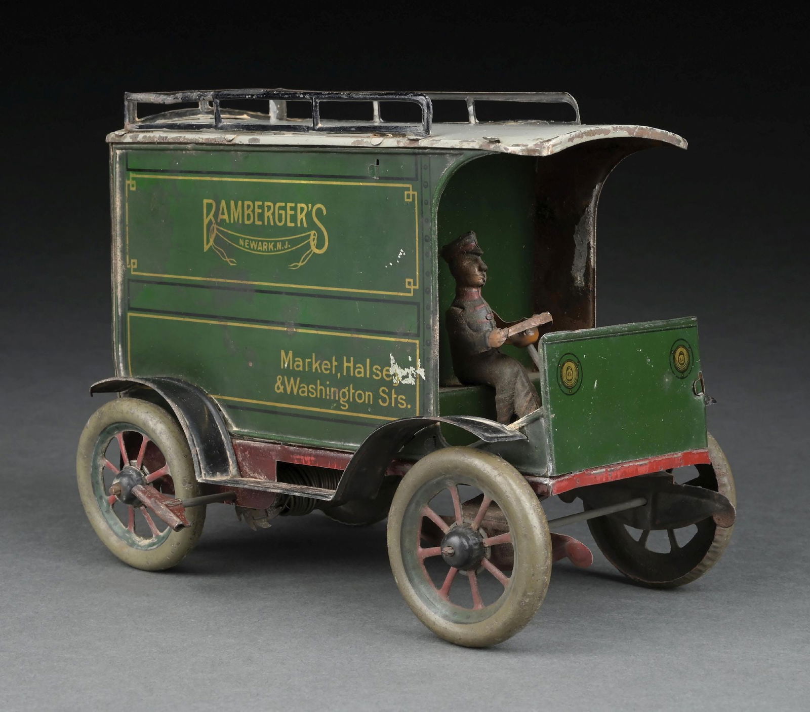 GERMAN TIN LITHO WIND-UP BAMBERGER'S TRUCK: Unmarked, but probably Hans Eberl. CONDITION: Original driver, original back doors. Some edge wear around roof and some minor scratching to sides. Very good to excellent condition overall. Dimensions: