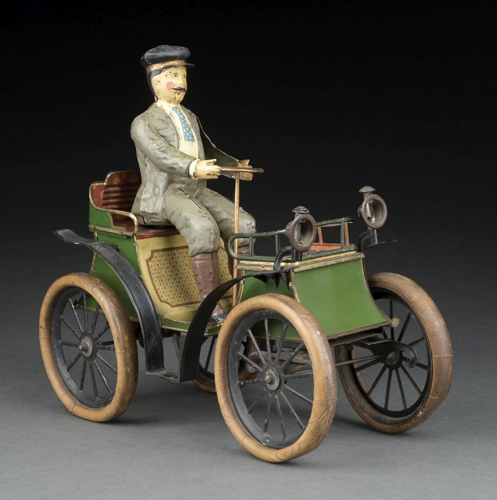 LARGE SIZE GERMAN GUNTHERMANN TIN LITHO VIS-A-VIS: This is the largest version of several sizes. Marked "James Melton Museum, Norwalk, Conn." on base of car. Shows man in suit with tie holding steering wheel and driving auto. Has the "SG" mark and win