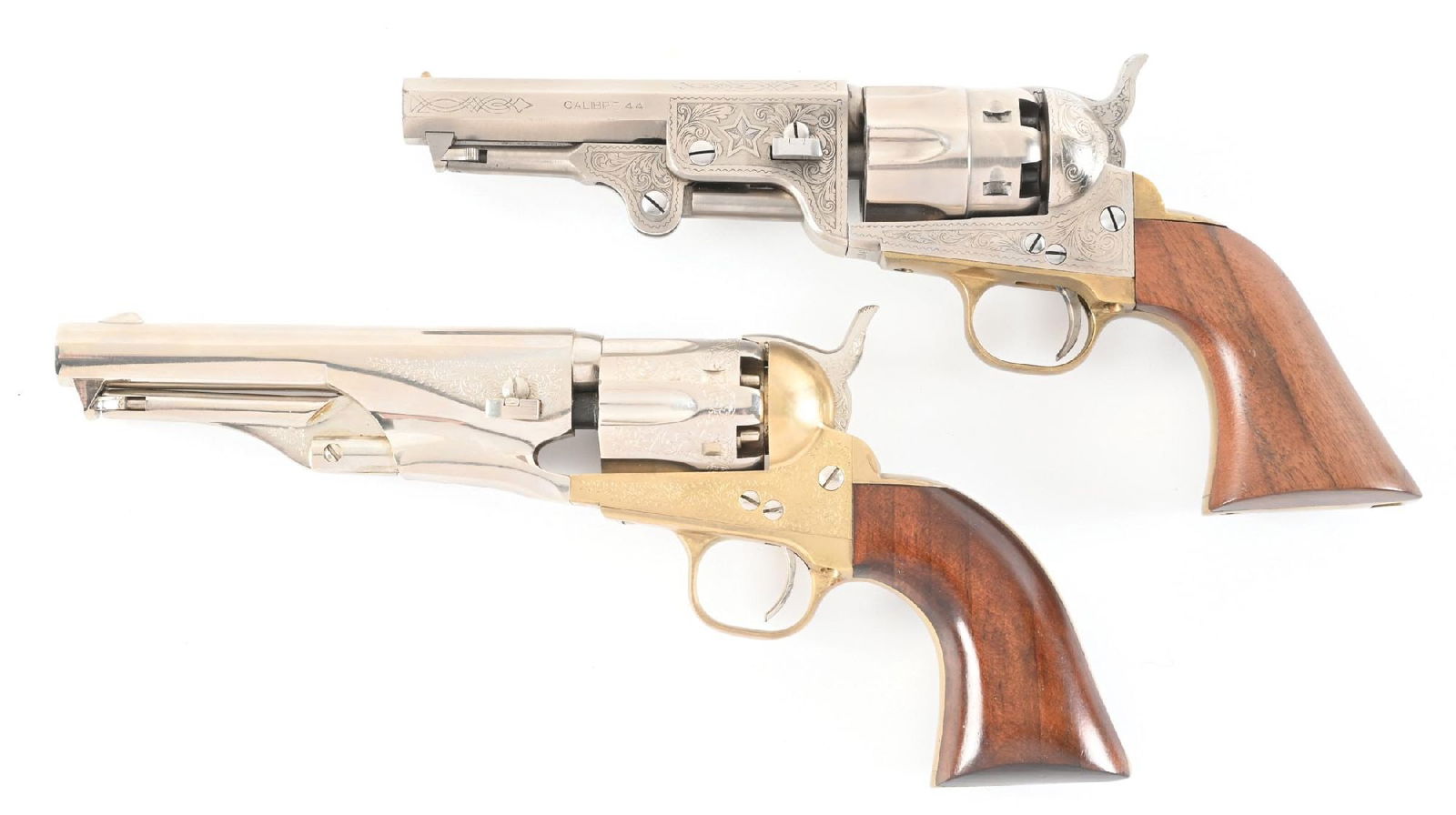 (A) LOT OF 2 BLACK POWDER SINGLE ACTION PERCUSSION REVOLVERS.: Lot consists of Gun (A) Italian black powder percussion revolver, with a in the white classic engraved finish, steel frame with a brass trigger guard, smooth walnut grips. CONDITION: Excellent: Shiny
