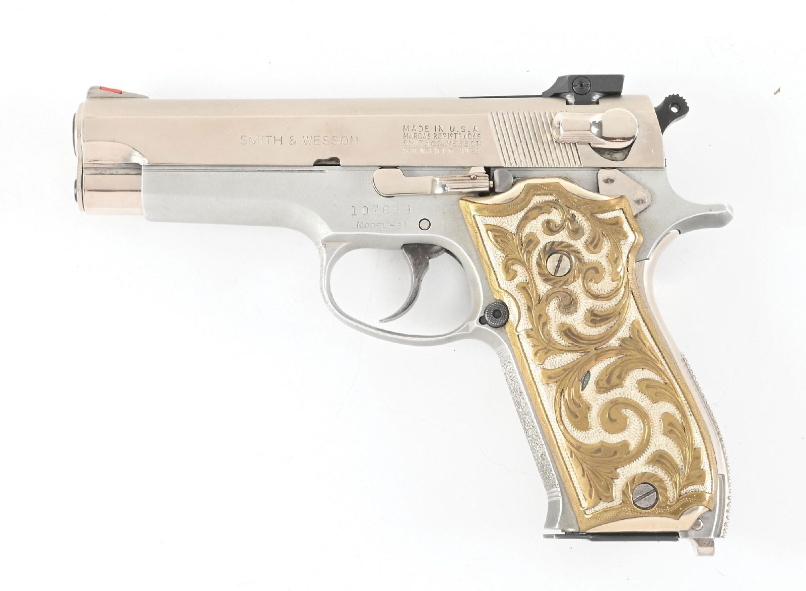 (C) SMITH & WESSON MODEL 39 SEMI AUTOMATIC PISTOL.: Manufactured pre-1970. Dual tone slide with red insert ramped front sight and adjustable MMC rear. Alloy frame mounted with custom floral brass grips. A set of smooth wood grips with S&W medallions, a