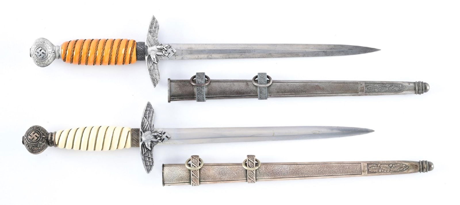 LOT OF 2: GERMAN WWII 2ND MODEL LUFTWAFFE DAGGERS.: Lot consists of: (A) Second Model Luftwaffe dagger with an unmarked blade that exhibits cross graining, light runner marks, and scattered spotting, along with an older cleaning. Nickel silver plated f