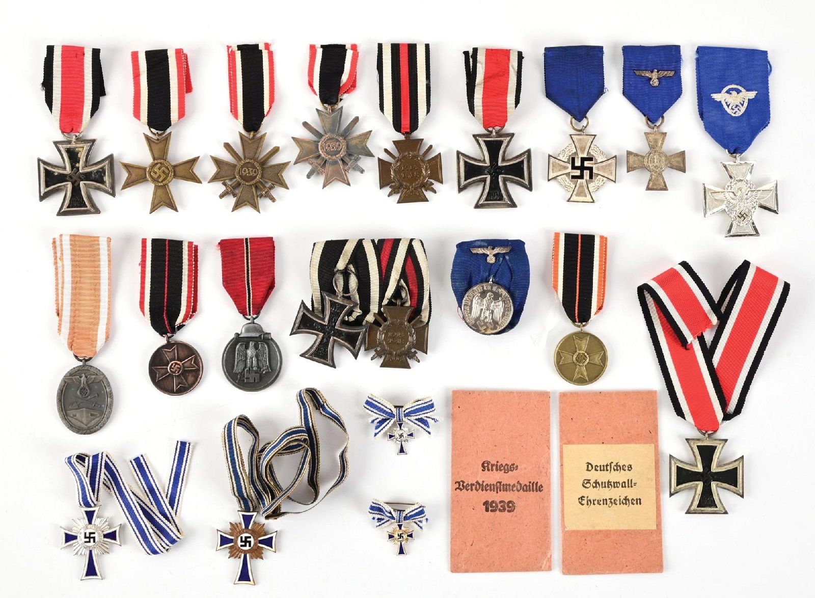 LOT OF THIRD REICH MEDALS, RIBBONS, AND BADGES.: The lot consists of various German World War II awards including three Iron Cross, three War Merit Crosses (two with swords), a West Wall Medal, an Eastern Medal, two War Merit Medals, a Police Long S