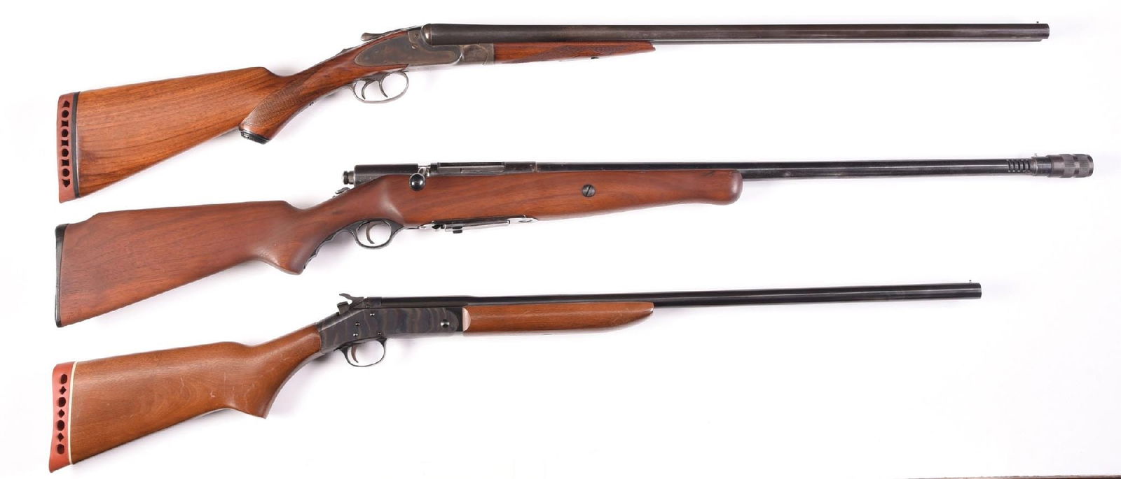 (M) LOT OF 3 SHOTGUNS: Lot consists of: (A) Mossberg Model 190, ported barrel with a " C-LECT - ACHOKE" permanently fixed to the barrel, 1 piece smooth walnut stock. Polymer trigger guard. CONDITION: Very Good, shiny bore.