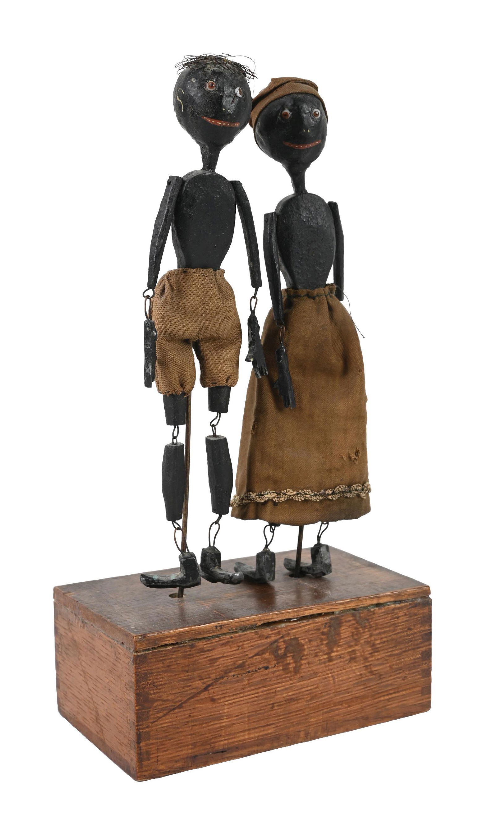 19TH CENTURY AFRICAN AMERICAN-THEMED CLOCKWORK DANCING TOY: Unmarked, but could be Automatic Toy Works. Depicts two African American figures made of wood, which looks like they have original cloth clothing and lead feet, dancing on top of a wooden box when wou