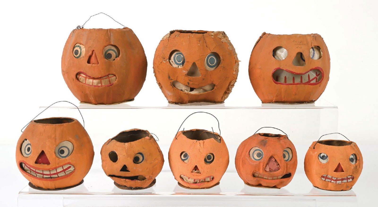 COLLECTION OF 8: HALLOWEEN JACK-O-LANTERNS: Lot consists of eight pressed cardboard pumpkin jack-o-lanterns. Each pumpkin shows various levels of wear and damage throughout but still a well displaying collection. Condition: (VARIOUS). Dimension