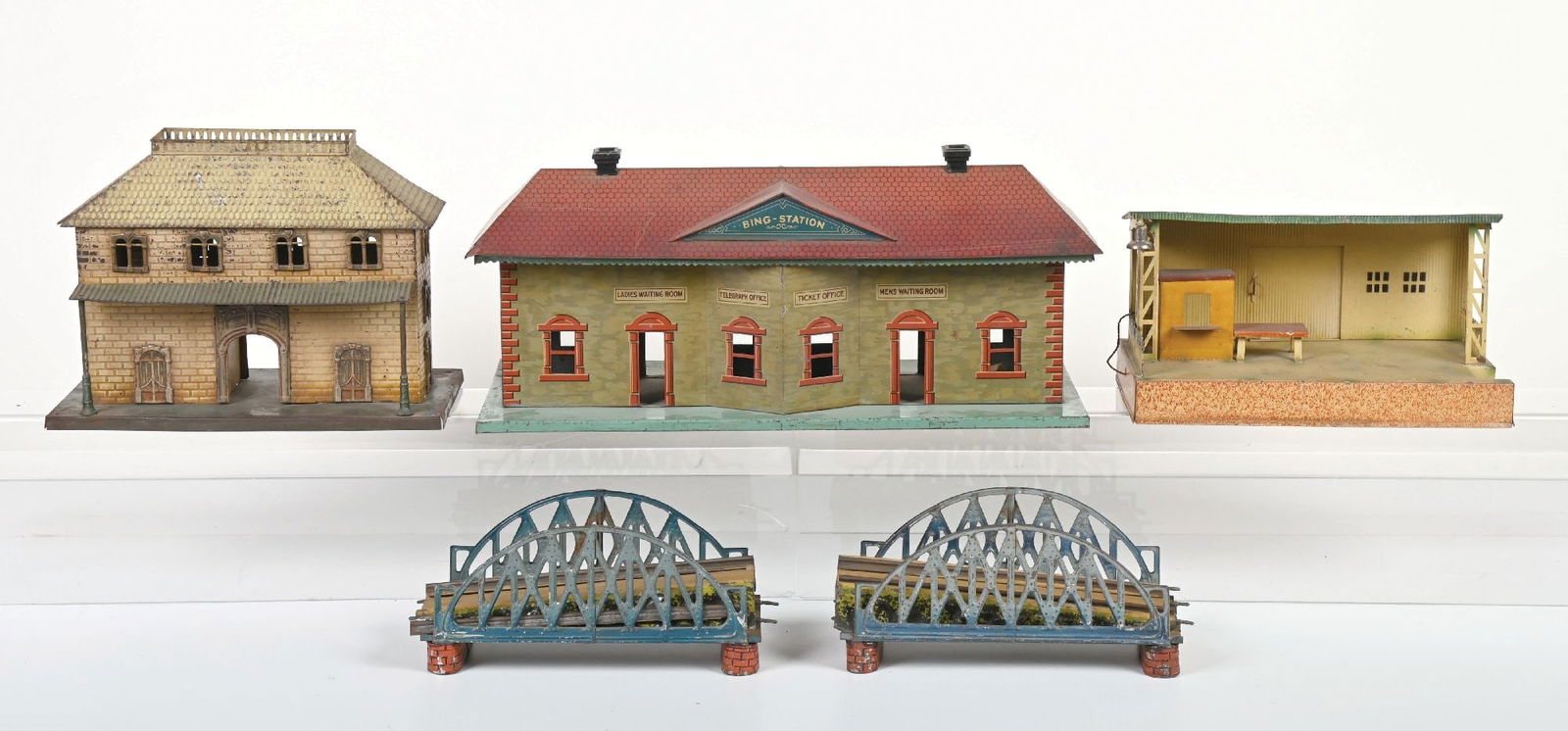 LOT OF 4: EUROPEAN STATIONS & BRIDGE: (A) Bridge for wind-up needs some track. Marked "Germany". There is some paint loss, mainly on the approaches. Very good condition. (B) Kibri Train Station in excellent condition. (C) Possibly Bing St