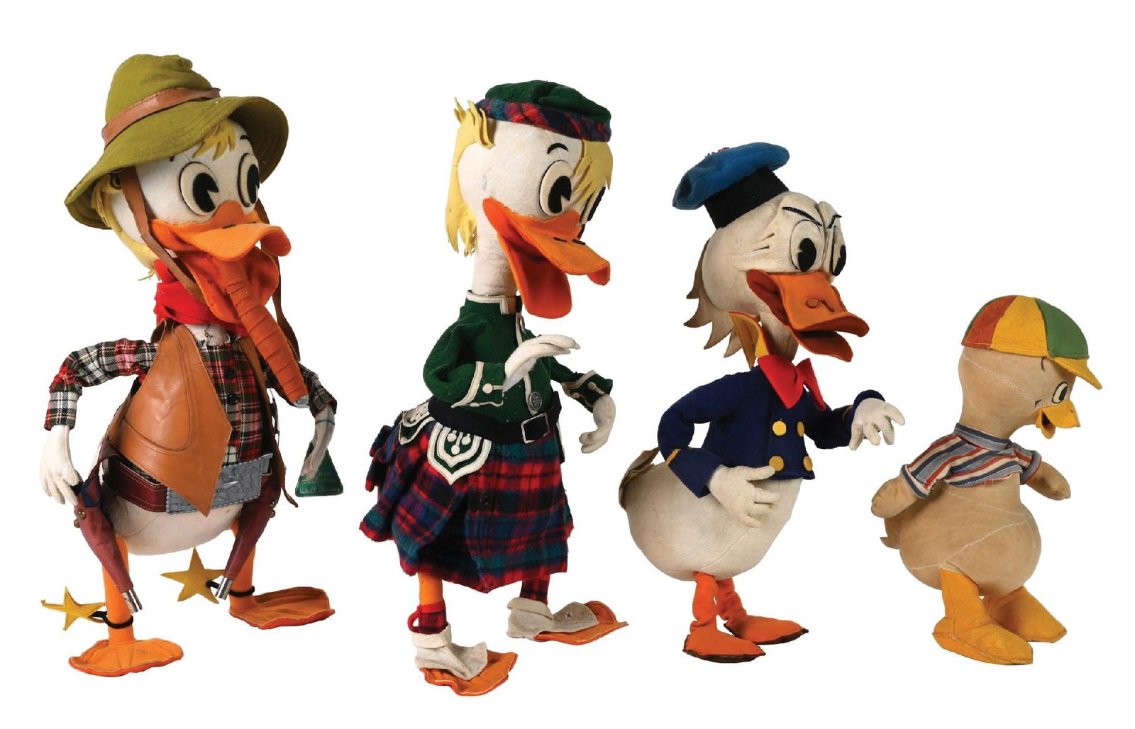 LOT OF 4: DISNEY DUCK FIGURES ITALIAN MID-20TH C.: All four have similar construction. (A) The largest is dressed as a cowboy, with a leather vest, gun belt and two toy guns in the holsters. He has a felt hat, which has a brown leather strap that fast