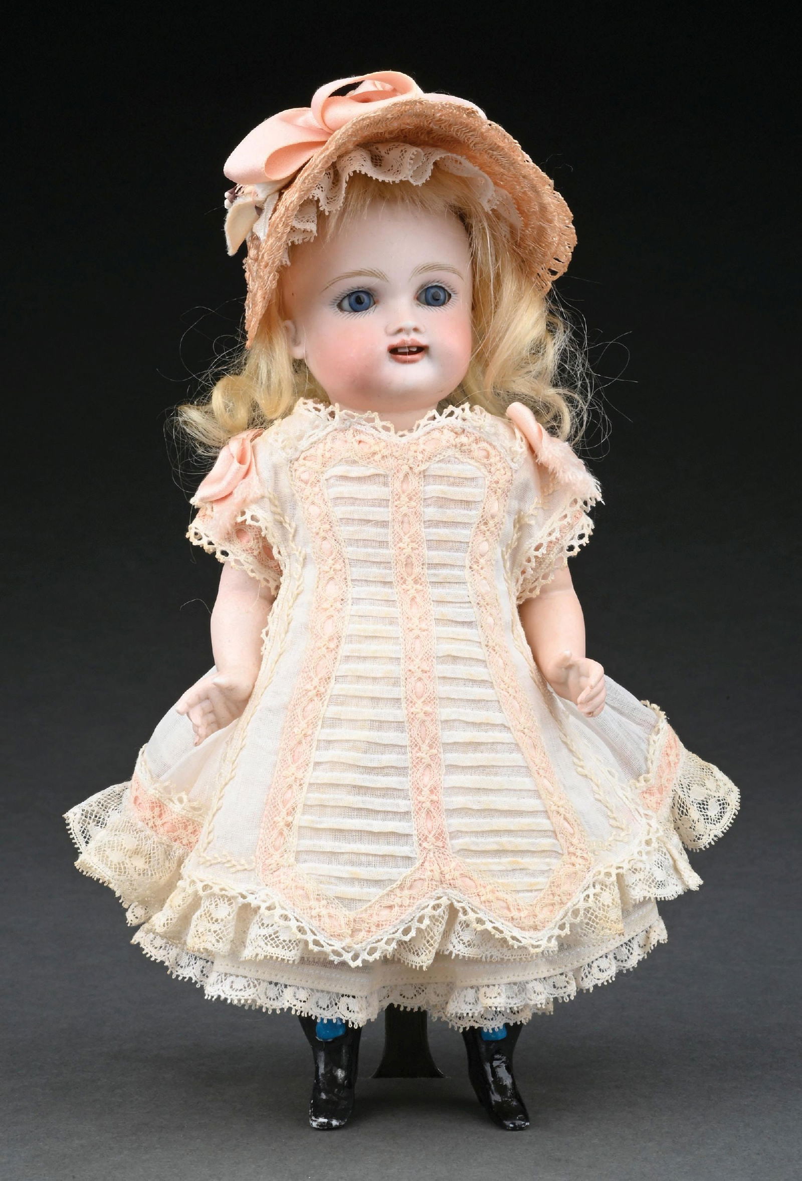 LOVELY 8-1/2" TALL BISQUE "WRESTLER": A lovely and desirable doll with a swivel head on all Bisque body with separately strung arms and legs, which have painted and molded high black boots, stockings and garters. The doll still has a plas