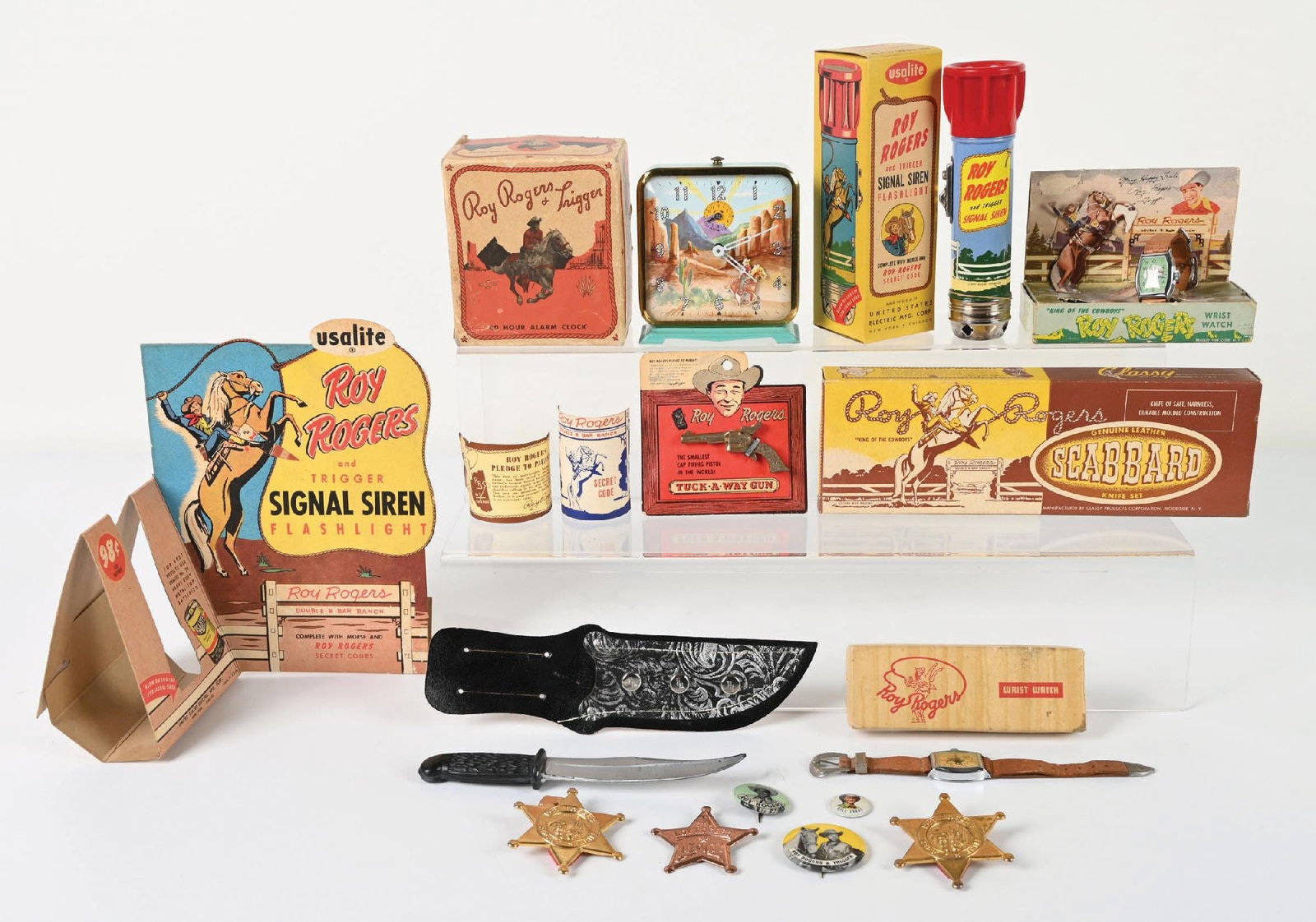NICE LOT OF ROY ROGERS & DALE EVANS VINTAGE ITEMS: Includes a light Roy Rogers counter display single-siren flashlight with original box and header card, Roy Rogers wristwatch which seems to be working, an Inghram alarm clock which needs repair, a wor