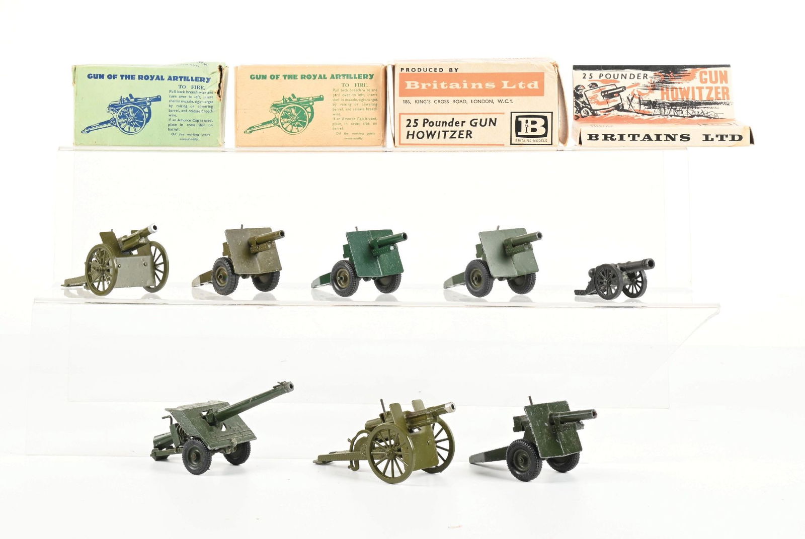 W. BRITAIN'S ARTILLERY ASSORTMENT: Various field guns and cannons, including: 2 25-lb. Howitzer Sets No. 9705, 2 Gun of the Royal Artillery Sets No. 1292, and several loose. 7 pieces total. Condition: (Very Good). Dimensions: Box: 13 -