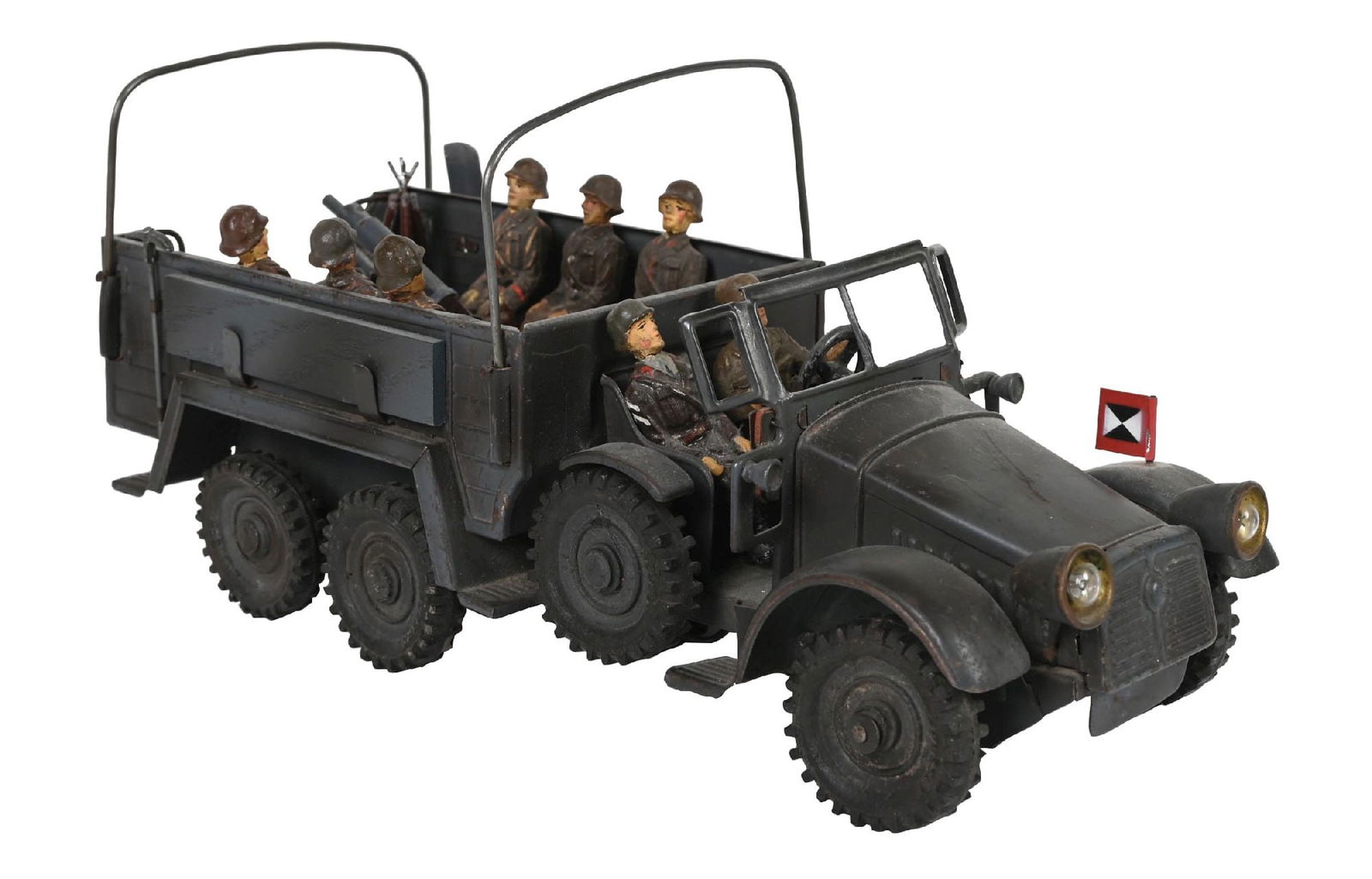 PRE-WAR TROOP CARRIER CAMOFLAGE GREY GERMAN CLOCKWORK: With canopy, machine gun, key, troops. Composition tires. Condition: (Very Good). Dimensions: 9 - 3/4" x 4 - 1/4" x 4 - 5/8". CORRECTION: Title updated. This lot is pre-war not post-war.