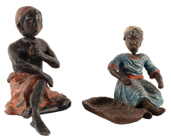 PAIR OF FEMALE BOBBLE HEAD CAST IRON FIGURINES