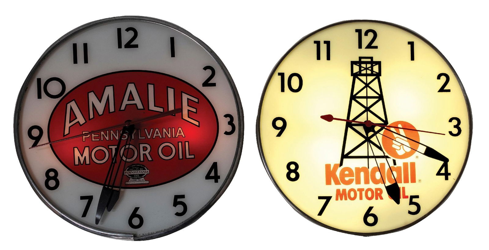 PAIR OF AUTOMOTIVE BUBBLE CLOCKS: CONDITION: (A) A Kendall Motor Oil bubble clock, with a graphic of an oil Derrick. It shows an original can, clock face, hands, and glass dome. Lights and runs. (Very Good). (B) An Amelie Pennsylvania