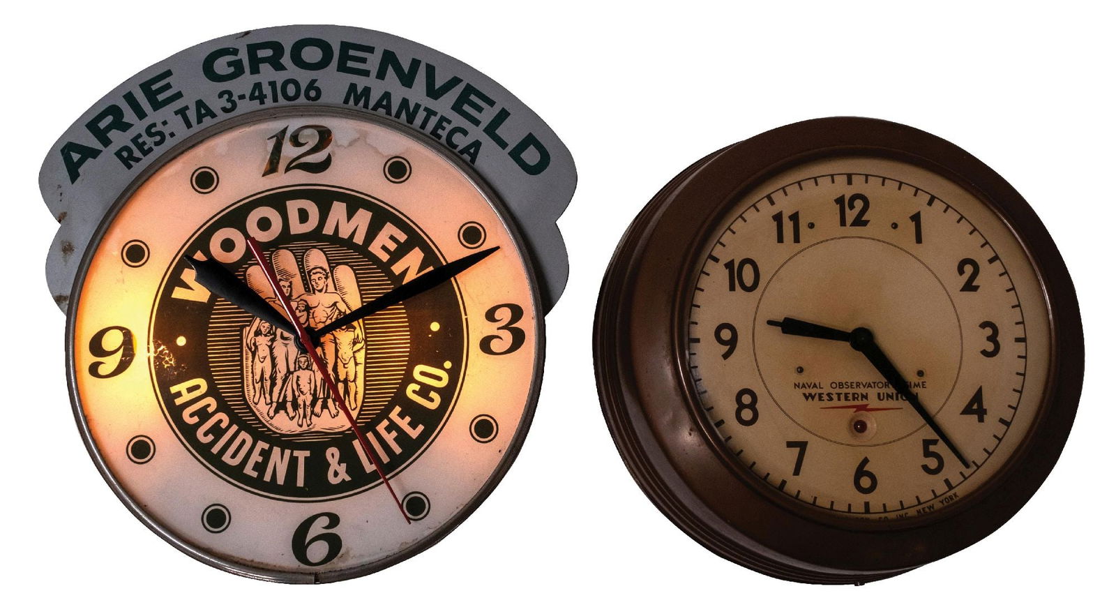 PAIR OF WALL CLOCKS: CONDITION: (A) A Pam bubble clock, advertising Woodman Accident & Life Insurance Company. It shows an original marquee, can, clock face, and hands. Lighting and operational. The top marquee shows some