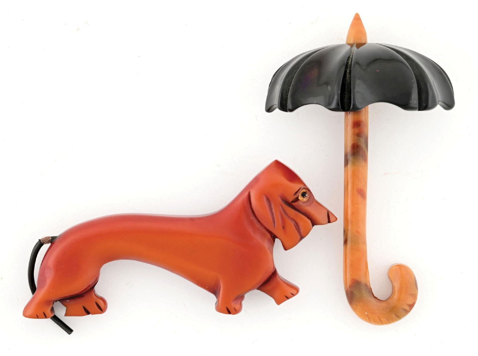 LOT OF 2: UMBRELLA & DACHSHUND BAKELITE BROACHES: Collection consists of one umbrella brooch with black shade and brown marbled handle and a brown dachshund brooch with coated rope tail. Pins are both in excellent shape with working pin backs. Condit