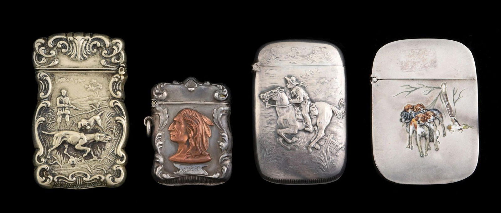 LOT OF 4: VINTAGE MATCH SAFES: Includes silver safe with hunting scene, enameled safe with hunting dogs, a silver cowboy safe and a mixed metal Indian safe. Condition: (Excellent). Dimensions: Largest: 1 - 3/4" x 2 - 1/2".