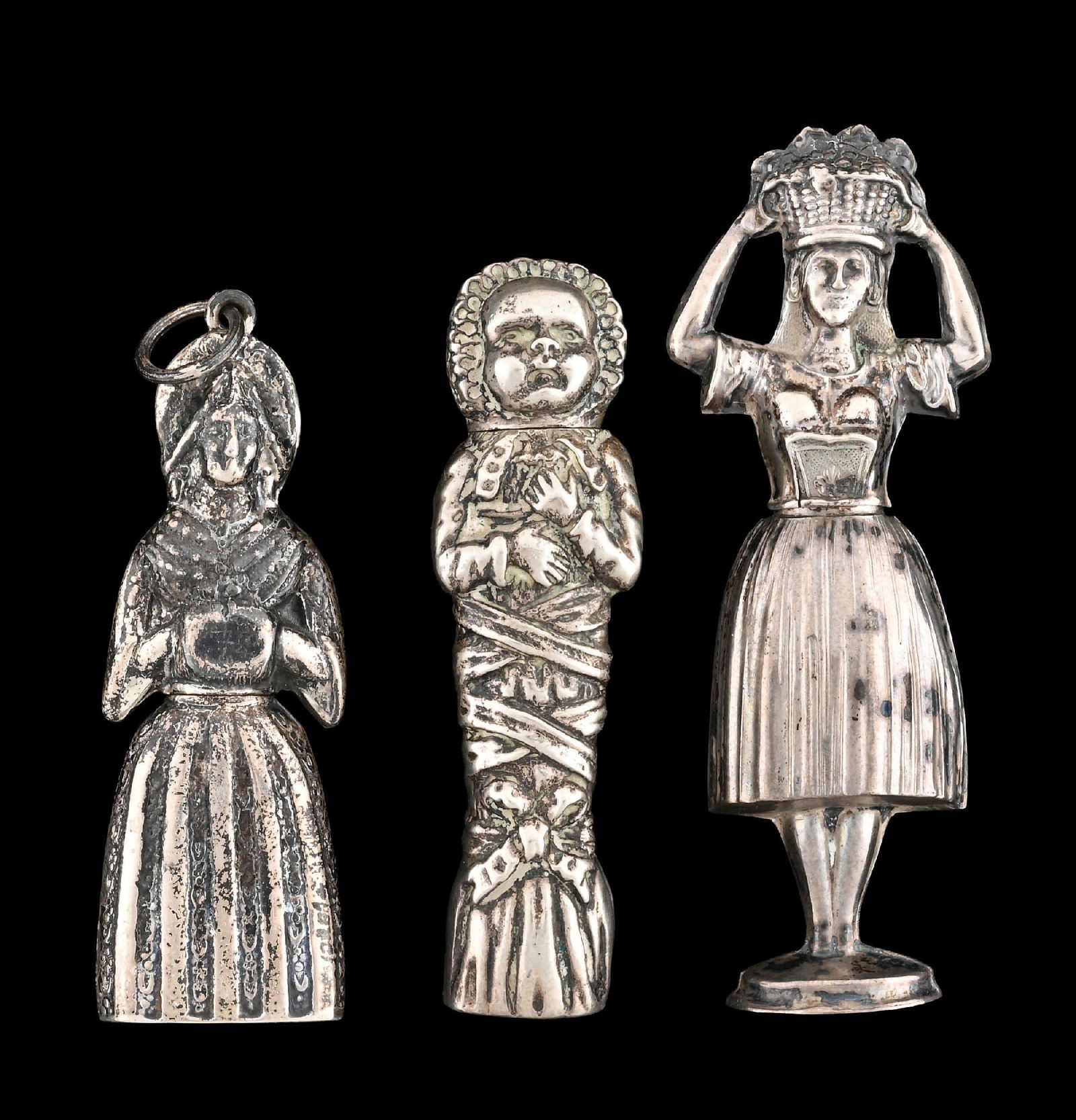 LOT OF 3: FIGURAL SILVER NEEDLE CASES: Includes three sterling silver figural needle cases. Lady with hand muff, lady with basket on head and baby in cradle. Condition: (Excellent). Dimensions: Largest: 3" T.
