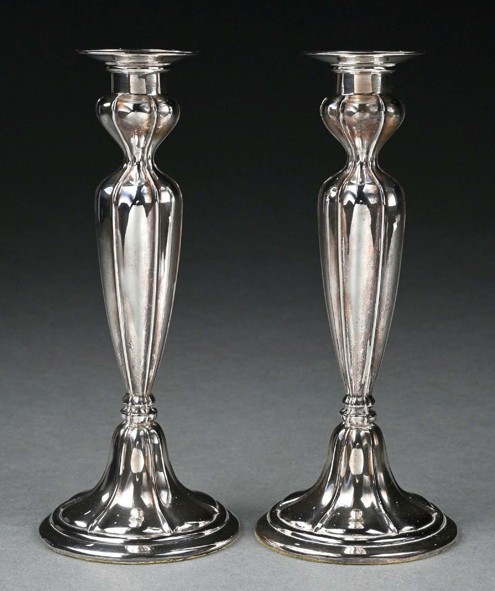 PAIR OF GORHAM STERLING SILVER WEIGHTED CANDLESTICKS: Marked Gorham with the lion, anchor and "G" hallmarks and "Sterling A10075". Weighted with green felted bases. Height is 8-1/2". Gross approximate weight is 29 ozt. Condition: (Very Good). Dimensions: