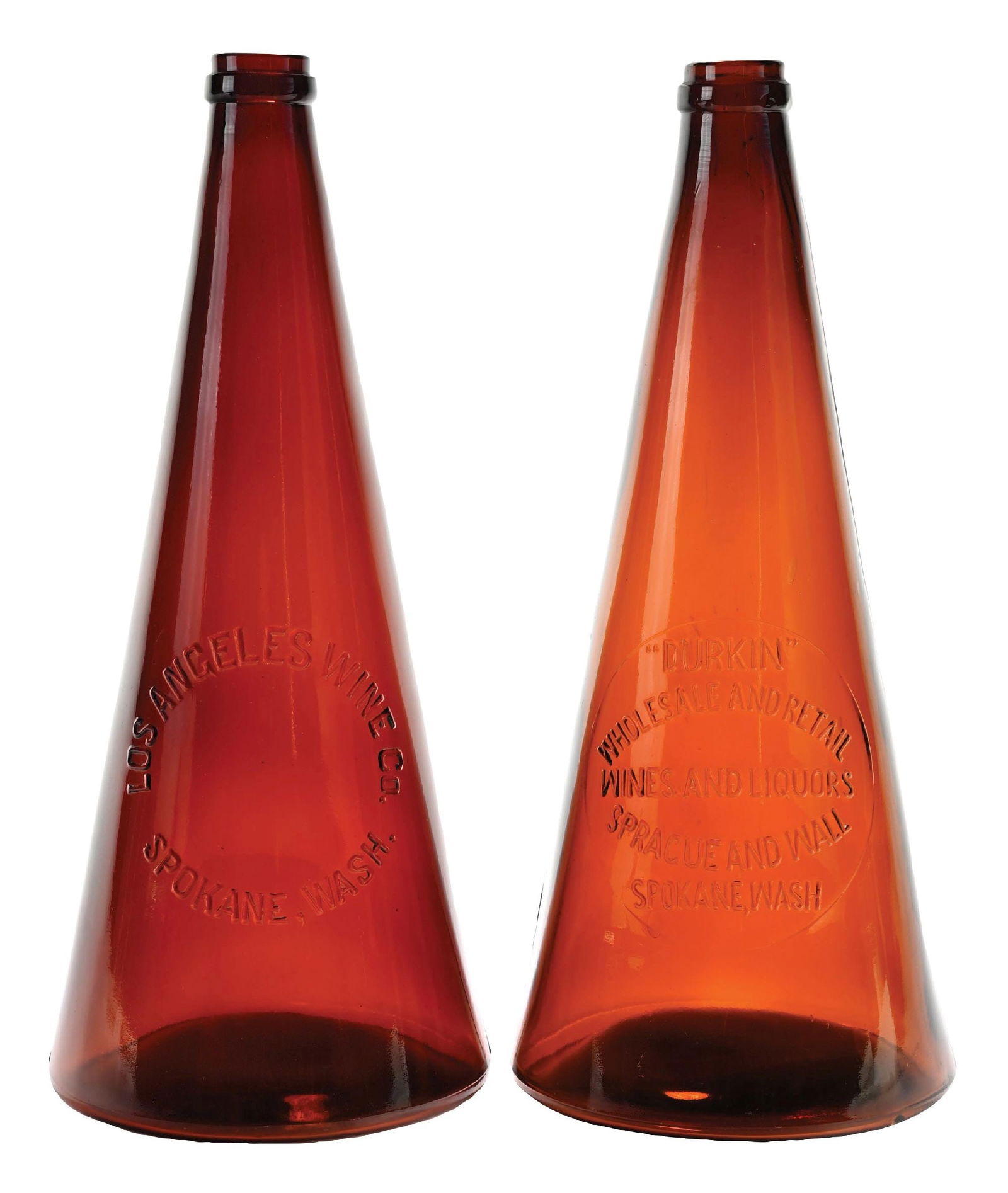 LOT OF 2: AMBER MEGAPHONE WINE BOTTLES: Both are BIM bottles with tooled tops, embossed on one side with circle slugs. (A) Embossed "LOS ANGELES WINE CO. SPOKANE, WASH.". Original paper labels are not present. This bottle is in near mint co