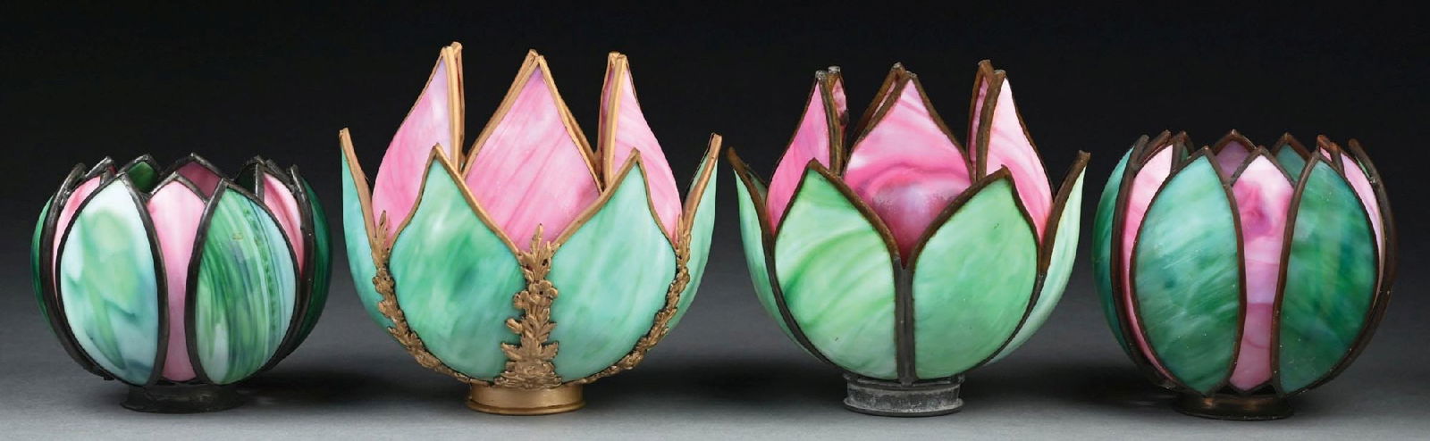 LOT OF 4: GREEN AND PINK SLAG GLASS LAMP SHADES: A very nice collection of four green and pink tulip-style slag glass lamp shades. Each of the tulip-style shades are composed of green and pink slag glass. There are a few cracks to several of the sla