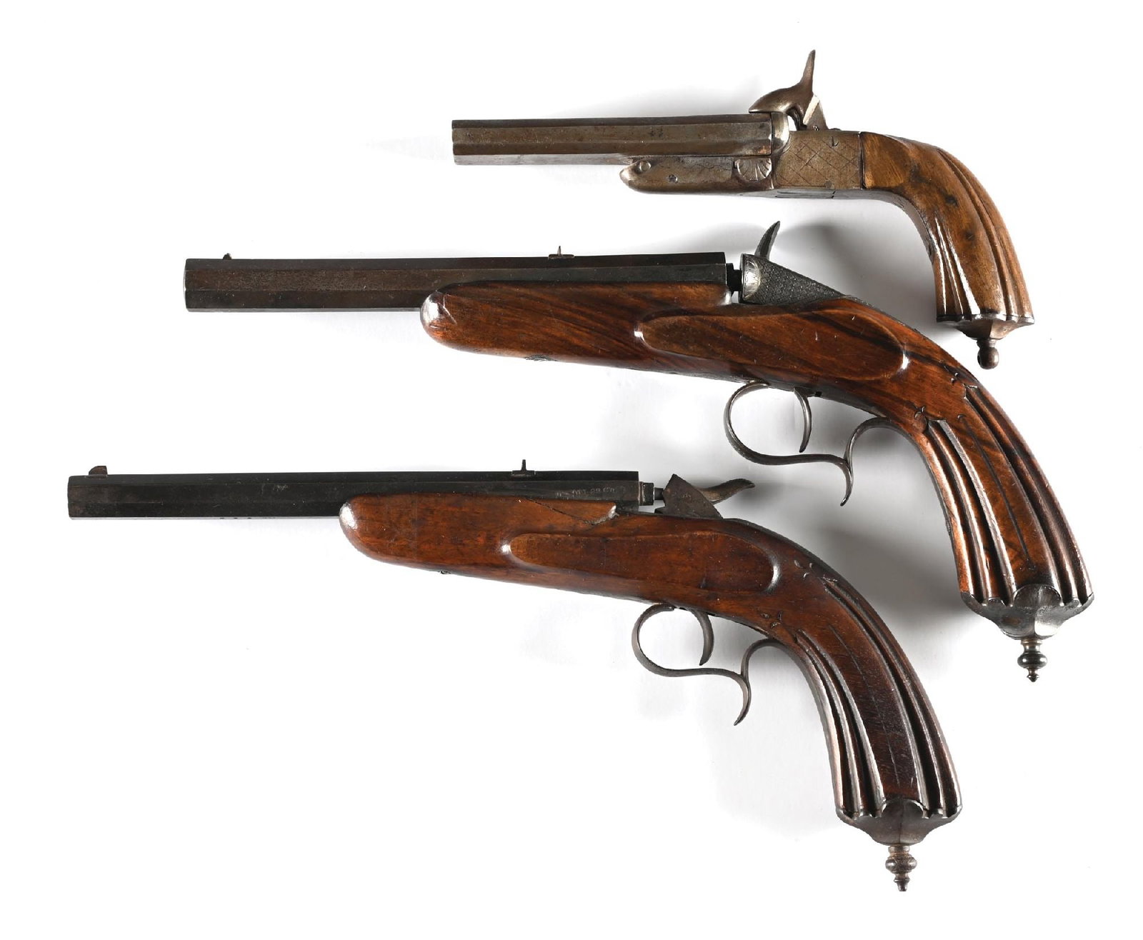 (A) LOT 0F 3: 2 PERCUSSION TARGET PISTOLS AND A DOUBLE BARREL PINFIRE PISTOL.: A. Double barrel pinfire, 11mm. octagon barrels, double exposed hammers, fluted wood stock and folding triggers. Metal is patina. Grips are fine. Working order. Bores are rifled and show abrasion. B. 