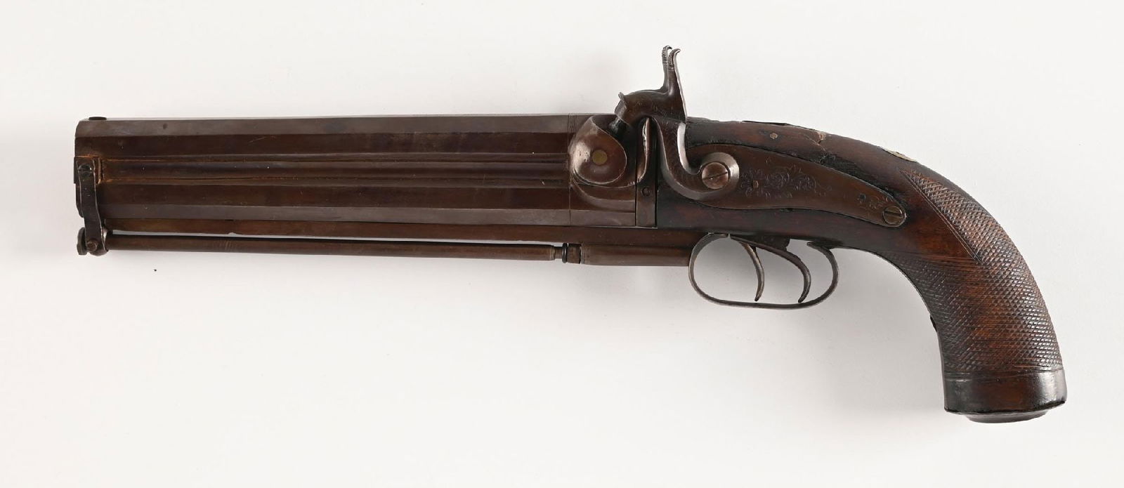 (A) HOLLAND & HOLLAND MARKED OVER UNDER PERCUSSION HOWDAH PISTOL.: This mid 19th century pistol features stacked double octagon barrels, dual triggers, engraved exposed hammers, walnut grip, checkered with metal butt that has a trap and the swivel loader. Sports twin