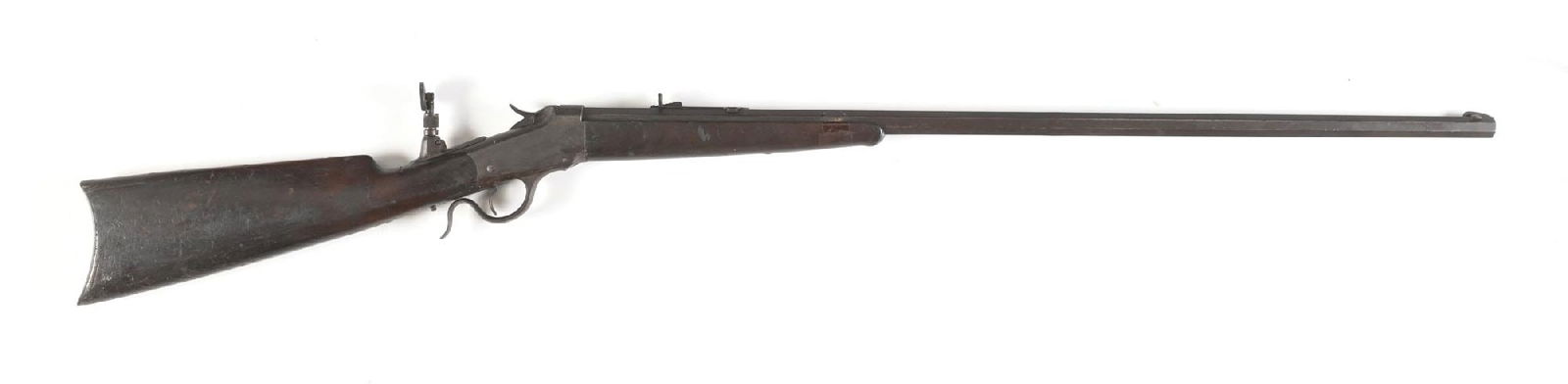 (A) WINCHESTER MODEL 1885 LOW WALL SINGLE SHOT RIFLE IN .32-20.: Dates to 1891. Features the tapered octagon barrel, dovetailed front sight, semi buckhorn rear sight, scarce heavy base tang sight, walnut stock with rifle butt plate and matching forearm with ebony i
