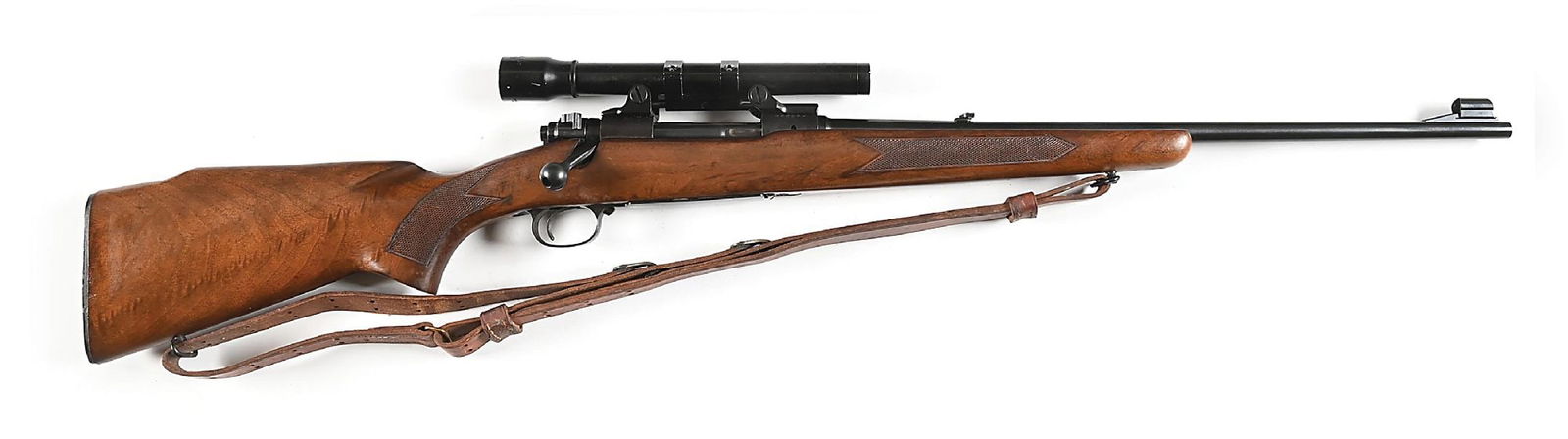 (C) PRE-64 WINCHESTER MODEL 70 FEATHERWEIGHT BOLT ACTION RIFLE IN .308 WINCHESTER (1961).: Manufactured in 1961 with blue finished metal. Bright polished bolt body with matching serial number. Varnished, checkered stock with pistol grip and plastic checkered buttplate. Mounted with Bausch a
