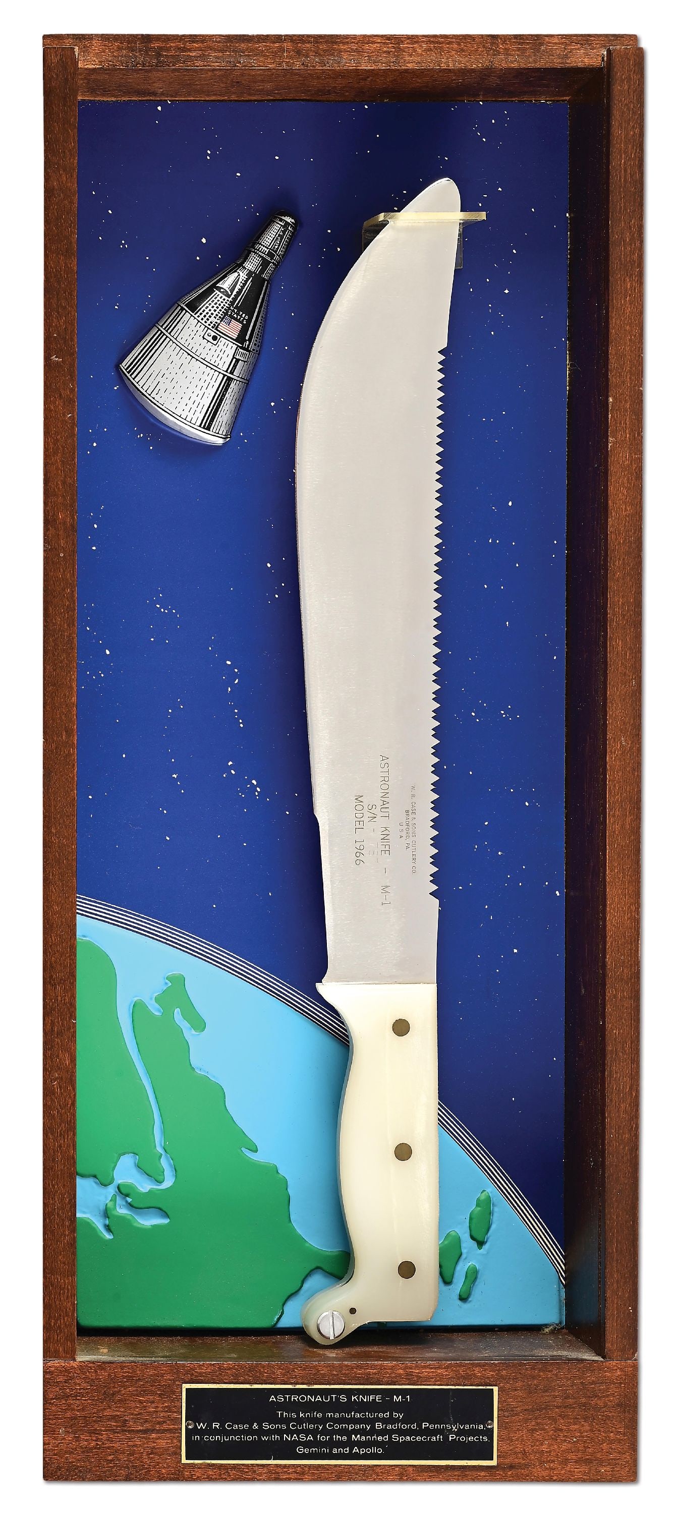 W.R. CASE & SONS MODEL M-1 1966 ASTRONAUT KNIFE.: Limited edition M-1 1966 astronaut knife manufactured by W. R. Case & Sons. The machete style knife features a stainless steel blade with serrated spine and is numbered "1787" on the obverse side. Whi