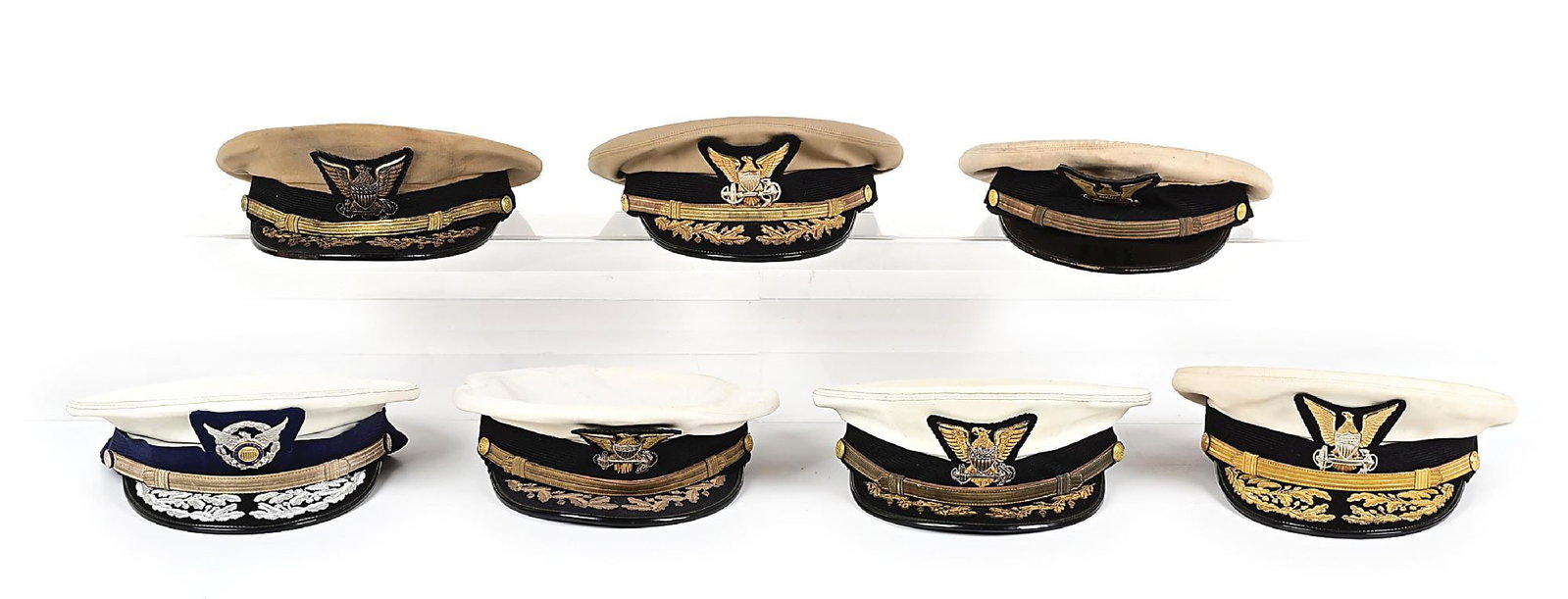 LOT OF 7: U.S. WWII-KOREAN WAR U.S. COAST GUARD OFFICER VISOR CAPS.: Lot consists of seven U.S. Coast Guard summer service and dress visor covers. Included are two admiral caps and a scarce auxiliary admiral example. All are correct to regulations with appropriate peri