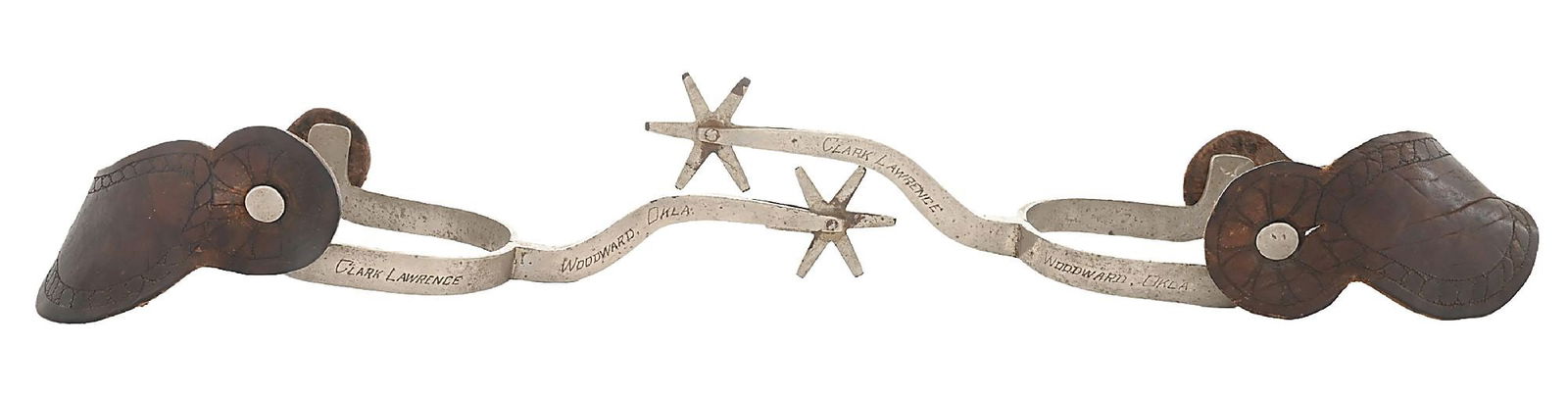 CUSTOM LONG SHANK TEXAS SPURS W/OWNER ID: Extremely long 5" shanked nickeled Texas spurs. Engraved on the shanks: "CLARK L. LAWRENCE / WOODWARD, OKLA.". Research shows that Lawrence was born on Llano, Texas in 1889, moved to Sayre, Oklahoma i