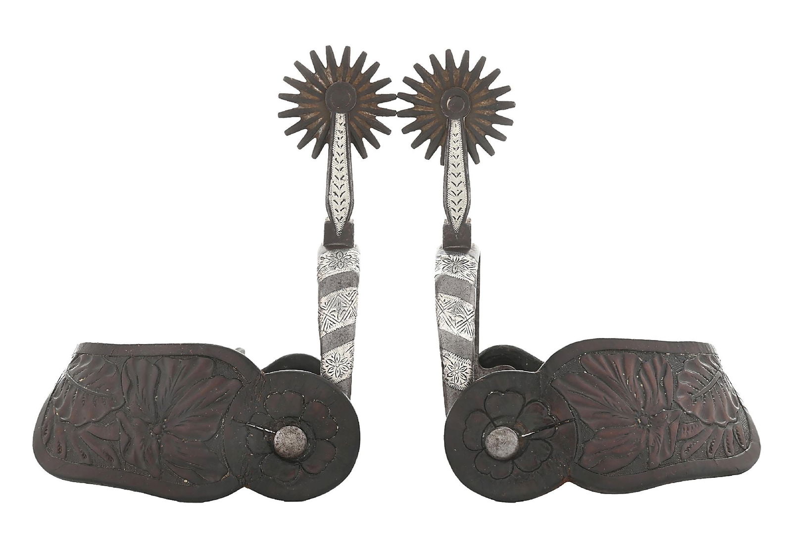 BUERMANN SPURS WITH LEATHER FLORAL TOOLED STRAPS: One-piece silver inlaid diagonals with floral motifs on the band. 20-point, 1-3/4" rowels. Marked with the early star and "Hand Forged Pat. Steel." Straps are period correct floral carved with nickel