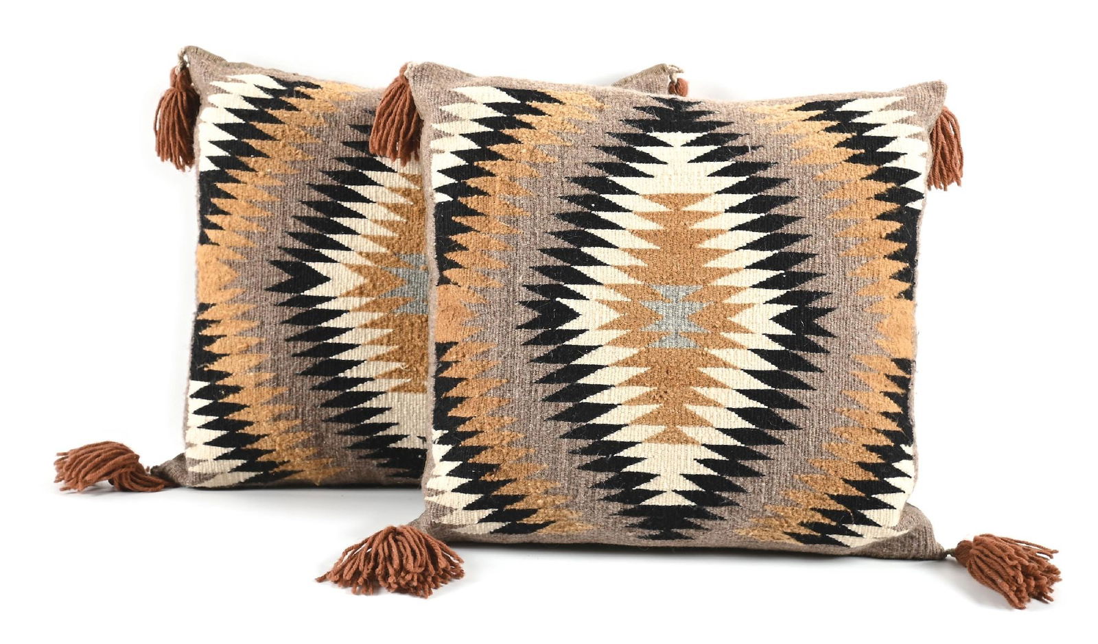 LOT OF 2: PILLOWS WITH NAVAJO (DINÉ) WEAVING ON FACE: Contemporary. With central serrated diamonds and each corner highlighted with a tassel. Dimensions: Each: 18" x 18".
