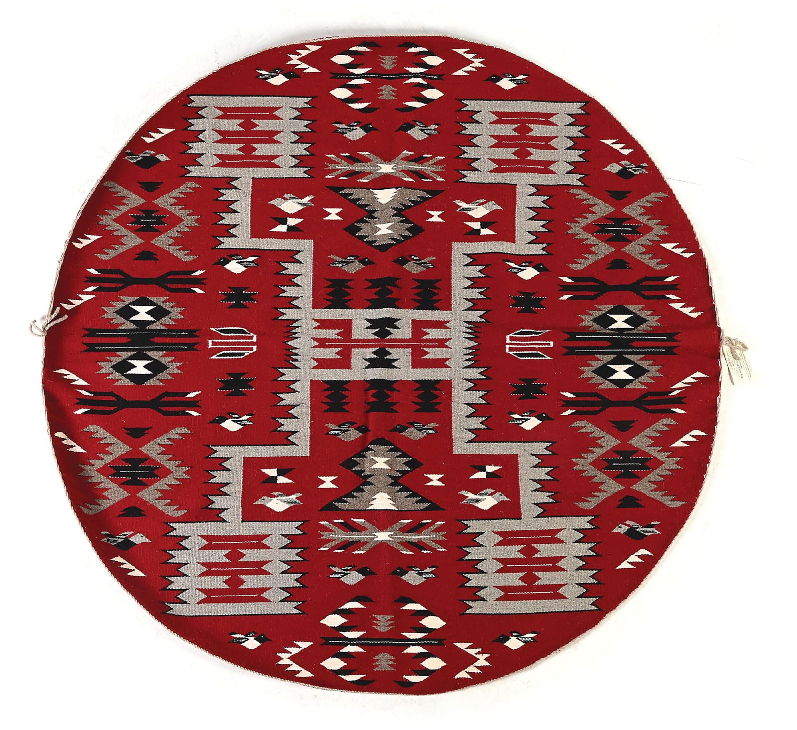 NAVAJO (DINÉ) CIRCULAR RUG: Contemporary. With Storm pattern surrounded by various geometric patterns, including water, bugs, and birds. Attached tag from Charles Eagle Plume Indian Store, stating "Weaver: Mary Yazzie". Dimensio