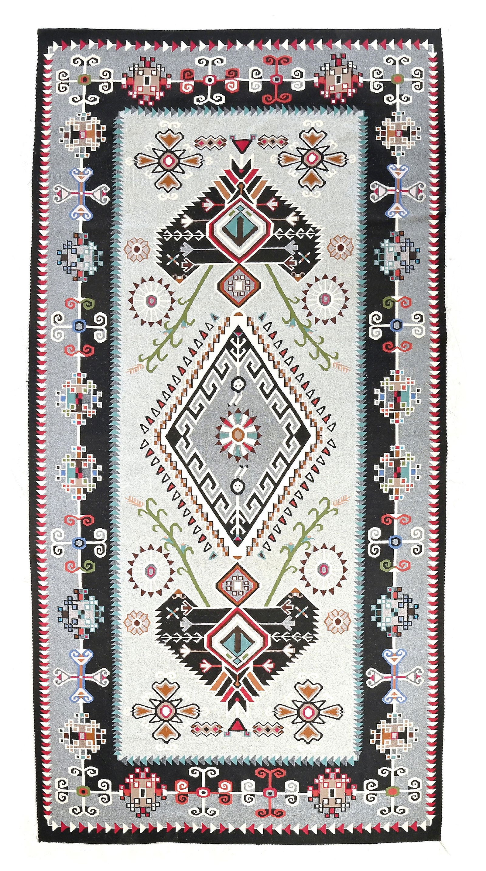 NAVAJO (DINÉ) LARGE RUG TEEC NOS POS: Contemporary. With a central circle flanked by stylized yei figures, expanding into a large diamond, flanked by two artistically-presented vases with realistic corn stalks growing out of each side. Th