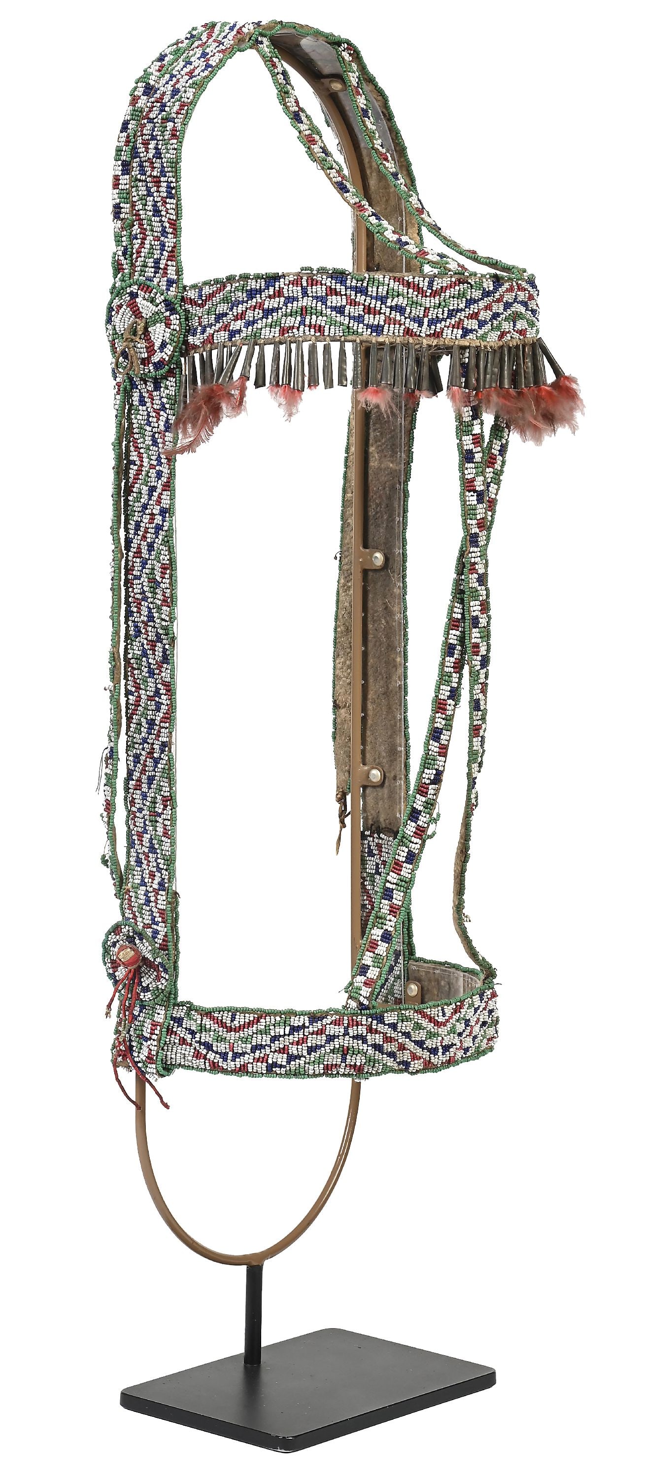 NORTHERN PLAINS BEADED HEADSTALL: Last quarter 19th century. Headstall is fully beaded in intricate checkerboard and zigzag designs. Also includes crisscrossed beaded face strips, throatlatch, and three beaded rosettes. Cones and red