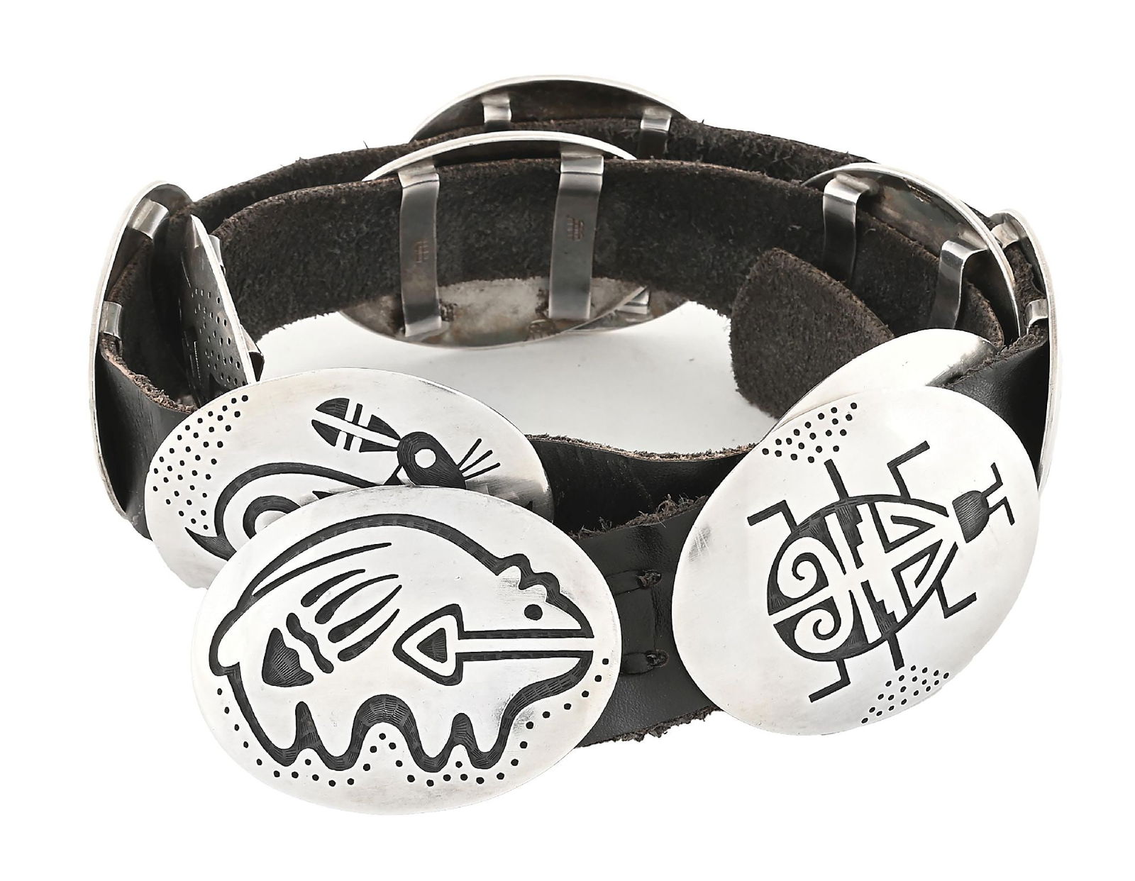 STERLING SILVER & LEATHER HOPI CONCHO BELT BY MANUEL HOYUNGOWA: Contemporary. Sterling silver and leather decorated concho belt. Signed with pictorial mark on each concho and on buckle for Manuel Hoyungowa. Buckle and conchos measure approximately 2-3/4" x 2" each
