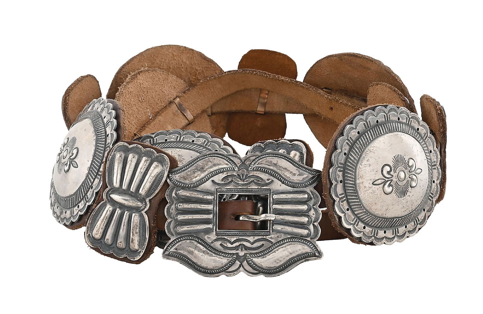 STERLING SILVER & LEATHER NAVAJO CONCHO BELT BY HARRY MORGAN: Contemporary. Sterling silver hand chased Navajo leather backed concho belt by Harry Morgan. Marked "Sterling" and signed "H .Morgan" on buckle. Conchos measure approximately 3-1/2" x 3" each.