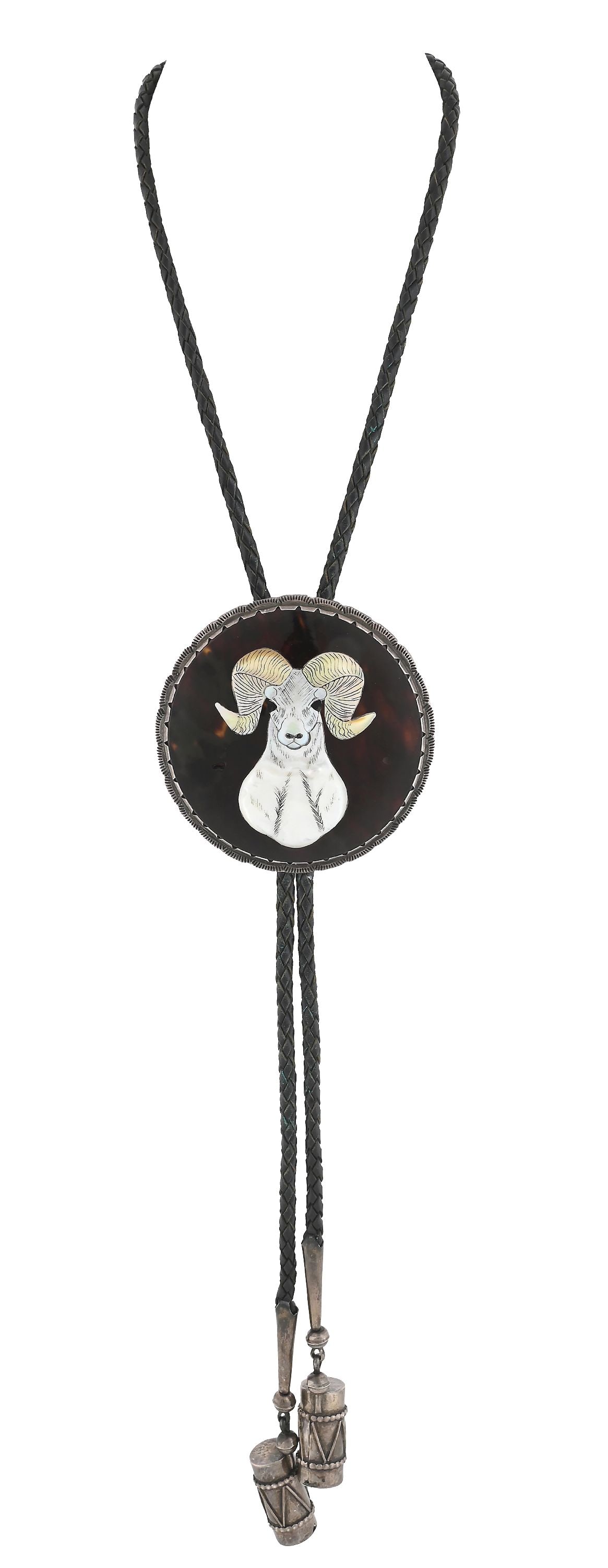 ZUNI (A:SHIWI) BOLO TIE: With a nicely-carved and detailed ram's head out of mother of pearl, encased in a silver stamped setting with silver Pueblo drum toggles. With hallmark on back. Dimensions: 20" Length.