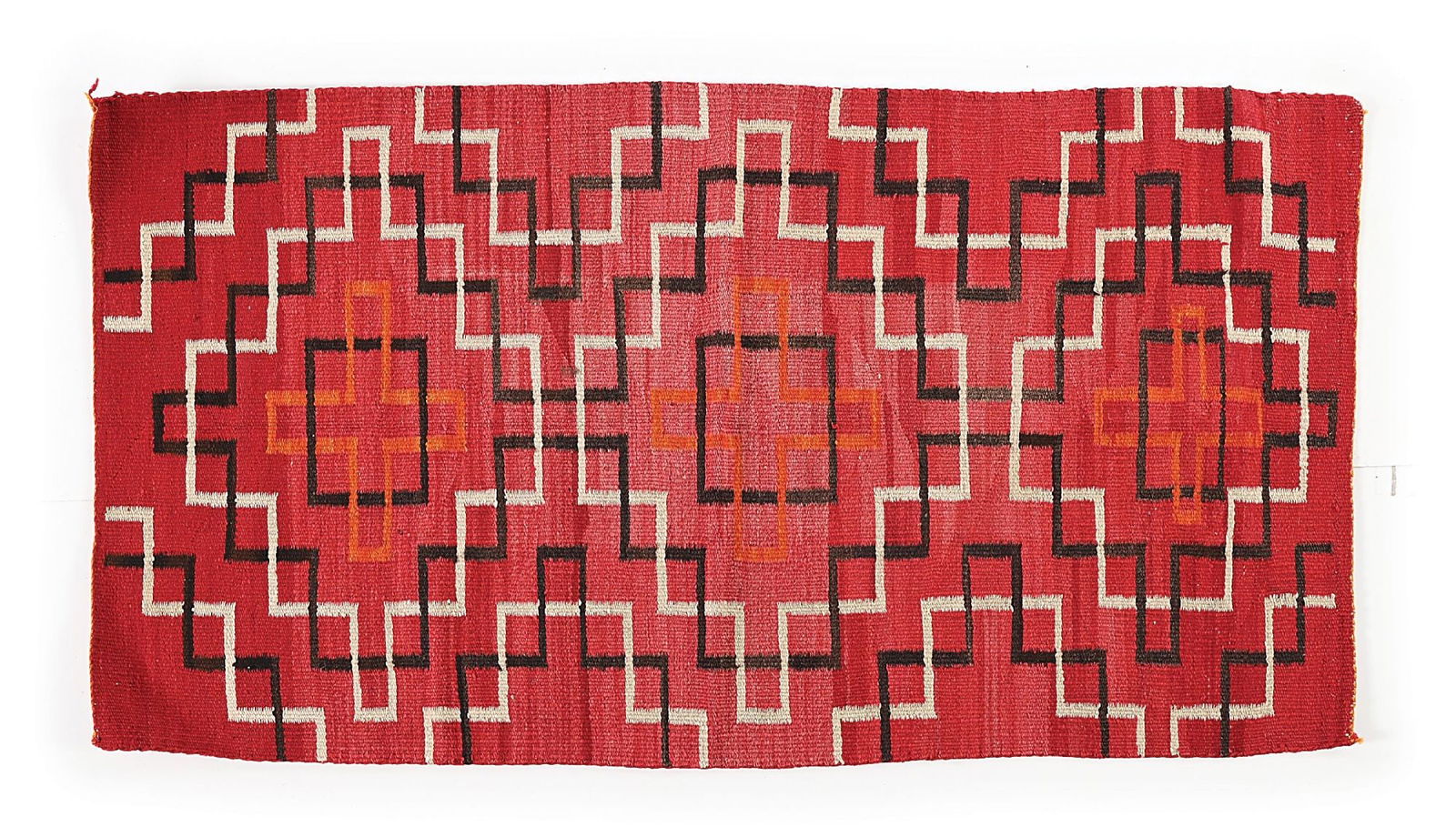 NAVAJO (DINÉ) RUG: Circa 1920s. With interlocking line pattern encasing three central cross motifs. Dimensions: 29-1/2" x 55" Condition: With slight staining. Colors: Red, Orange, Black, White Dimensions: 29 - 1/2" x 55