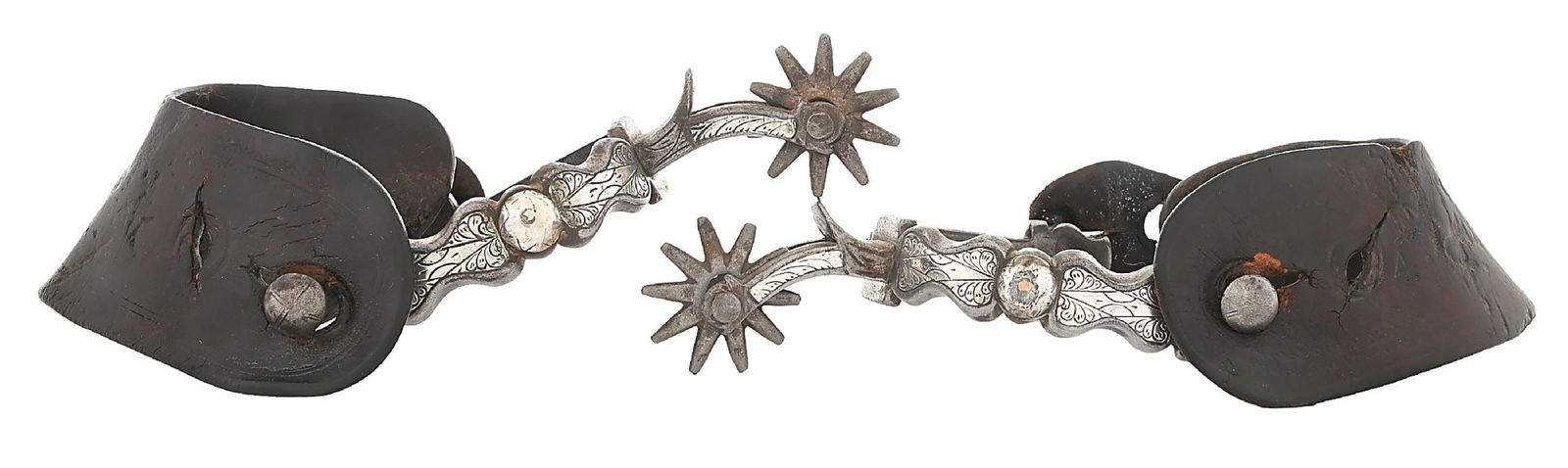UNMARKED SILVER MOUNTED CALIFORNIA SPURS: Single-mounted, San Jose-style California pattern spurs with central dome and engraved "peanut" panels. Shown in the Buermann catalog as #1403 but unmarked. Period set of stamped leathers. Dimensions: