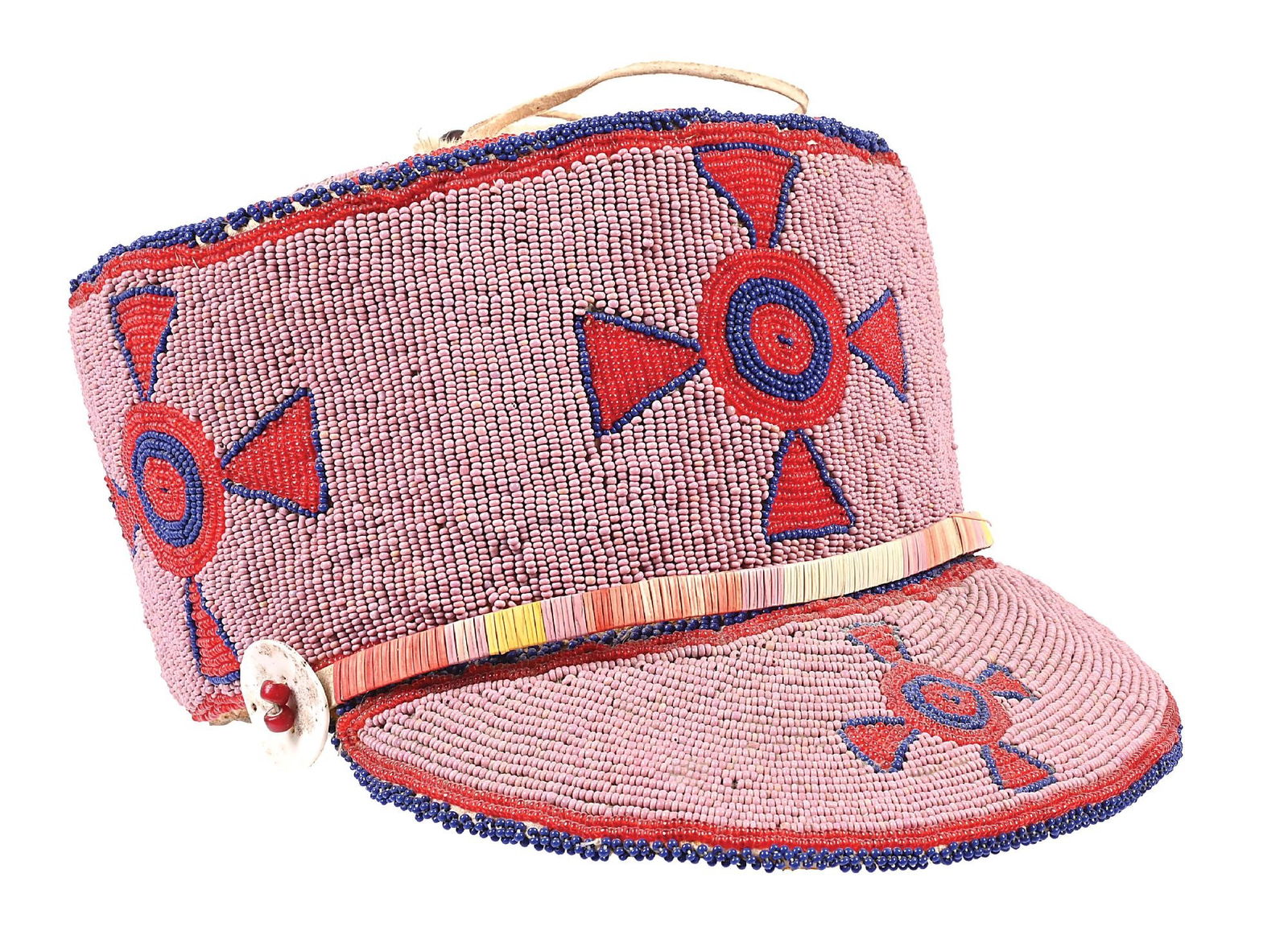 BLACKFOOT/PLATEAU BEADED CAP: Circa turn of the 19th century. A bead decorated French Legionnaires-style native-made deerskin and rawhide cap or kepi. The top with a nine triangle pointed wheel on a center circle, the sides and bi
