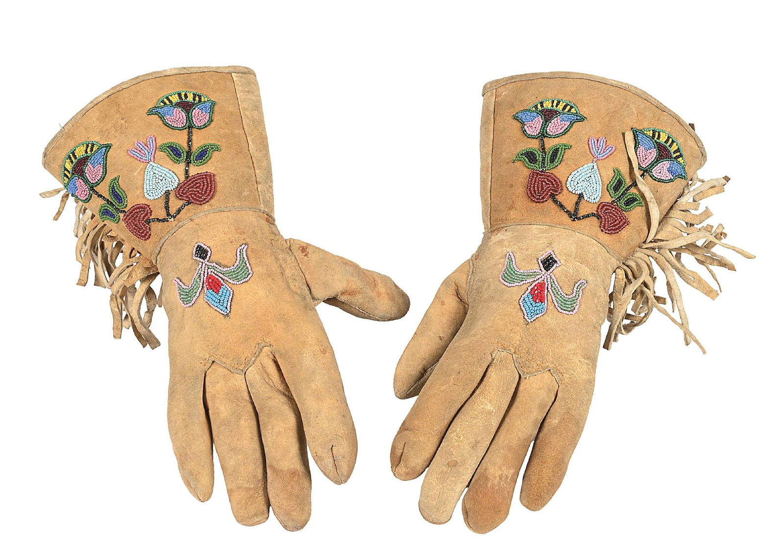 BLACKFOOT BEADED GAUNTLETS: With floral beaded design and fringe on moose hide. Dimensions: 12 - 1/2" Length.