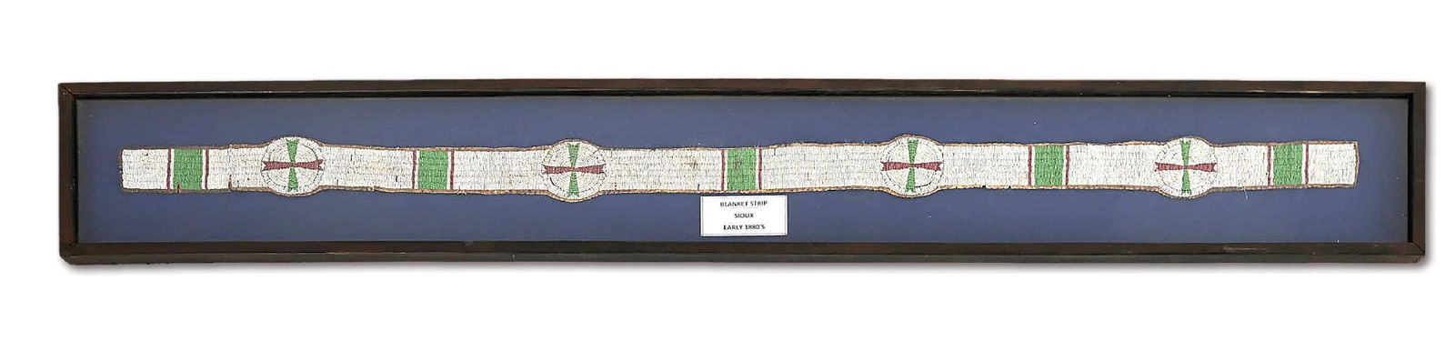 SIOUX (LAKOTA) BLANKET STRIP: Circa last quarter 19th century. Sinew-sewn and fully beaded with four rosettes, offset by rectangular blocks design. Professionally framed. Bead Colors: White, Green, White-Center Red This is not a s