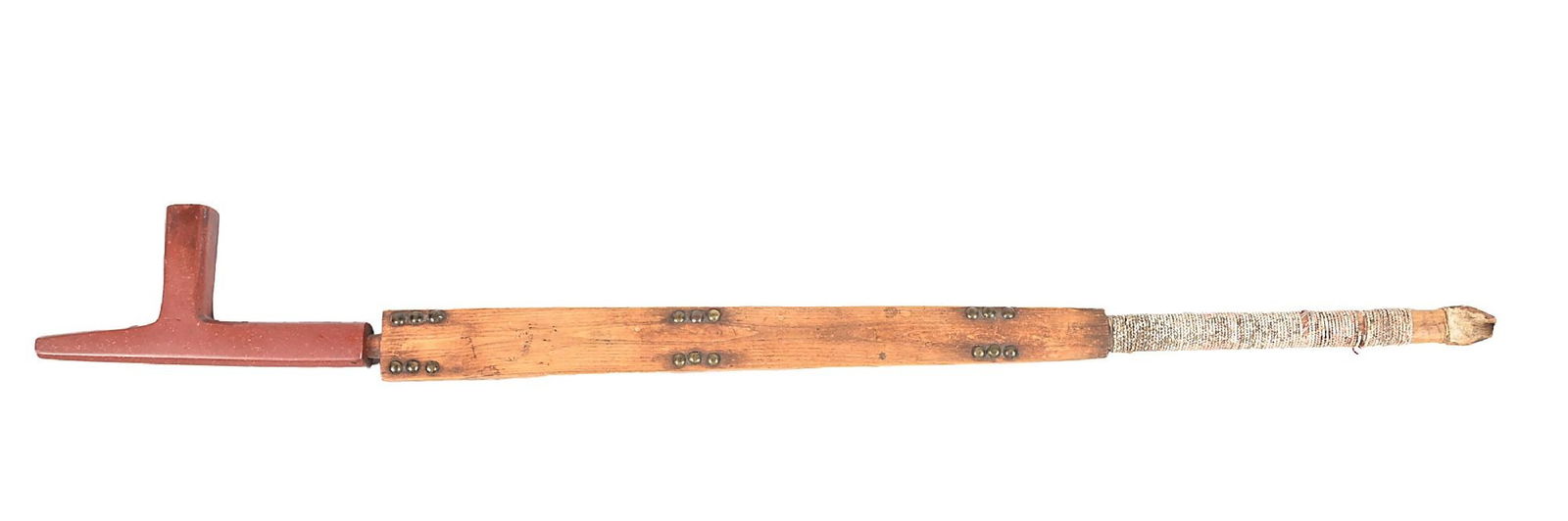 PLAINS PIPE AND STEM: With a plain catlinite bowl and a wooden stem with three sections of brass tacks and braided quillwork extending to remnants of bird feathers. Dimensions: Largest: 1 - 1/2" x 25".