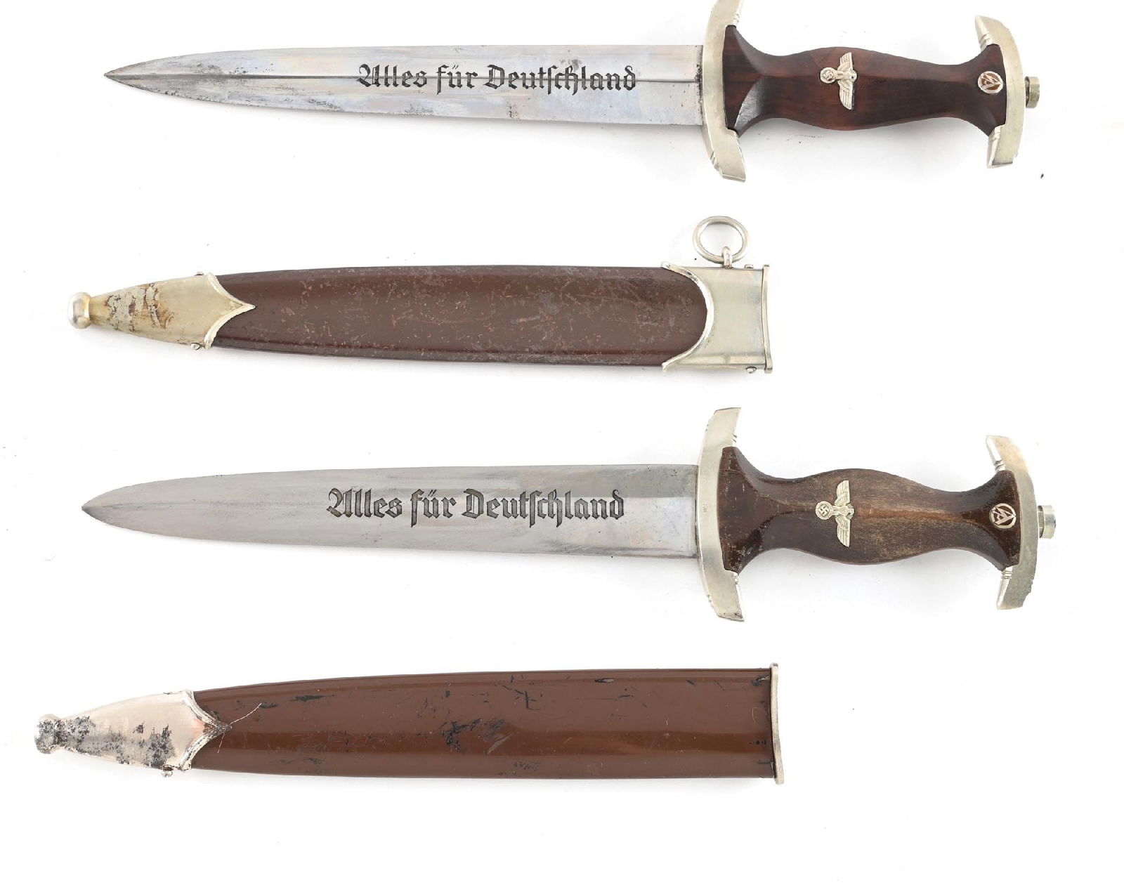 LOT OF 2: THIRD REICH SA DAGGERS.: Lot contains: (A) SA dagger with a "GEBR. HELLER" marked blade with runner and scattered marks, light freckling, and visible cross graining. Nickel fittings have scattered marks, patina, and the cross
