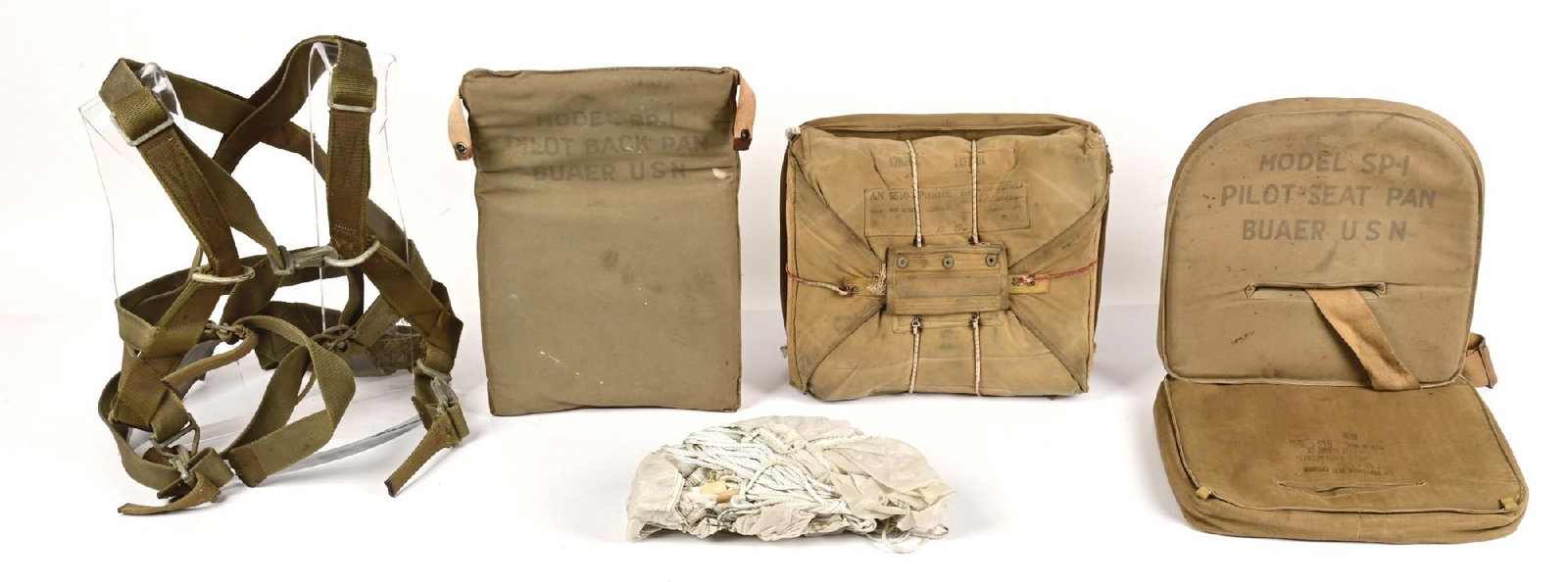 US WWII NAVY AND AIR CORPS PARACHUTE PARTS.: Lot consists of World War II US Navy and Army Air Corps parachute parts including am AN-6510-1 parachute pack (dated 1943) with foam stuffing and padded seat, USN Bauer model BP-1 back pad with Bauer 