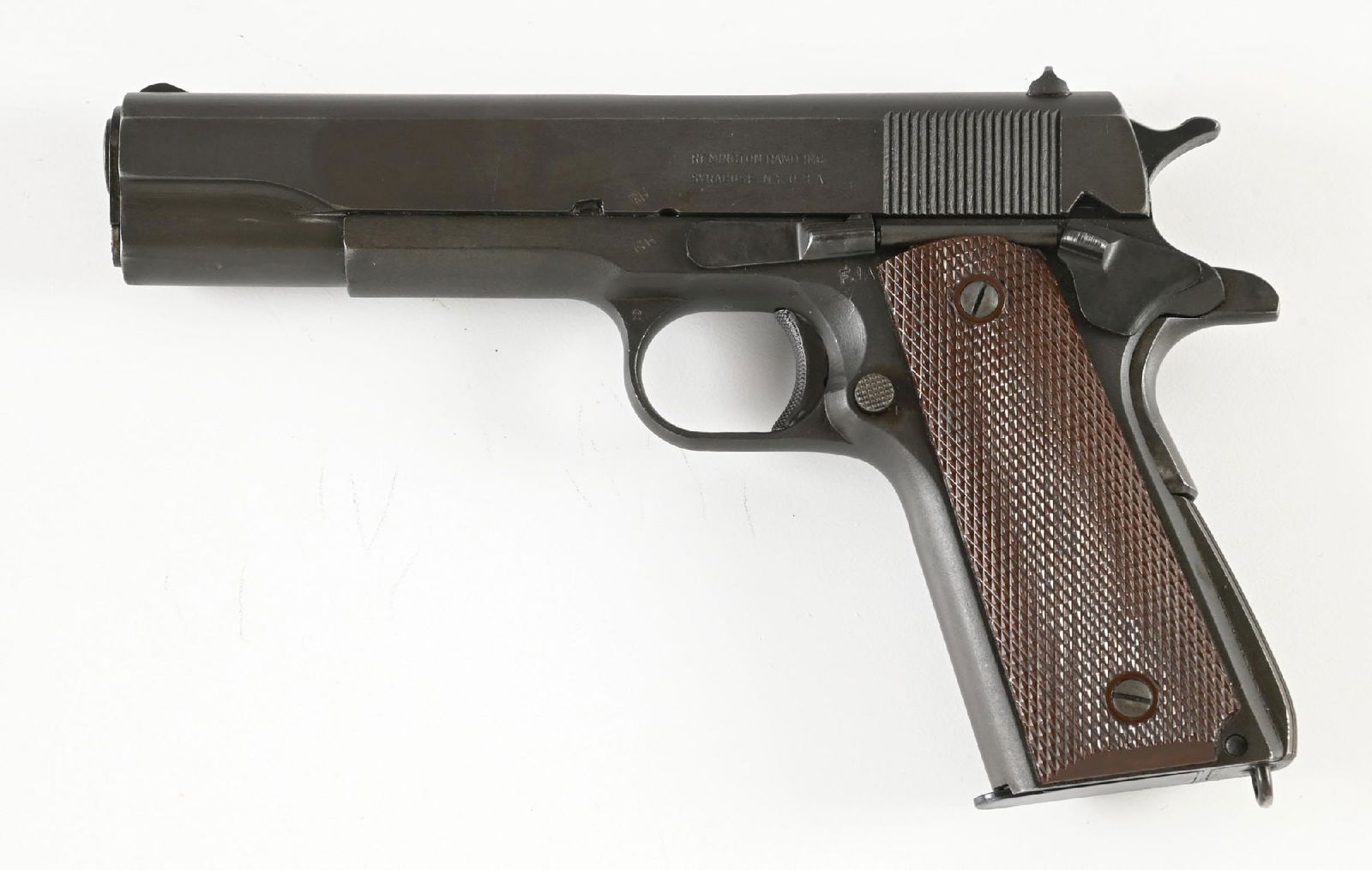(C) REMINGTON RAND M1911A1 SEMI-AUTOMATIC PISTOL (1943): Circa 1943 per serial number. Serrated slope front sight, square notch flat top rear sight, "P" proof ahead of rear sight, left side with Remington Rand legend. Barrel with "P" proof on left lug, "HS"