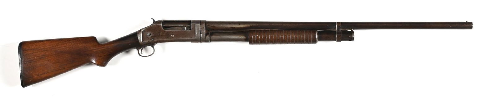 (C) WINCHESTER 1897 16 GAUGE SLIDE ACTION SHOTGUN.: Dates to 1907. Standard takedown, blue finish, plain barrel with bead front sight, plain walnut stock with pistol grip, Winchester gutta percha buttplate, and grooved forearm. CONDITION: Good. Hammer