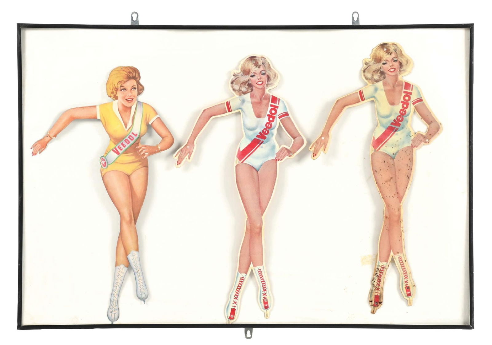 SET OF THREE TIN VEEDOL SKATER GIRLS FIGURAL SIGNS FRAMED BEHIND GLASS: SST. Three individual tin skater girl signs from Veedol Motor Oils. CONDITION: Each arena good condition with bright color & gloss, the one at the right showing areas of staining that appear to possib